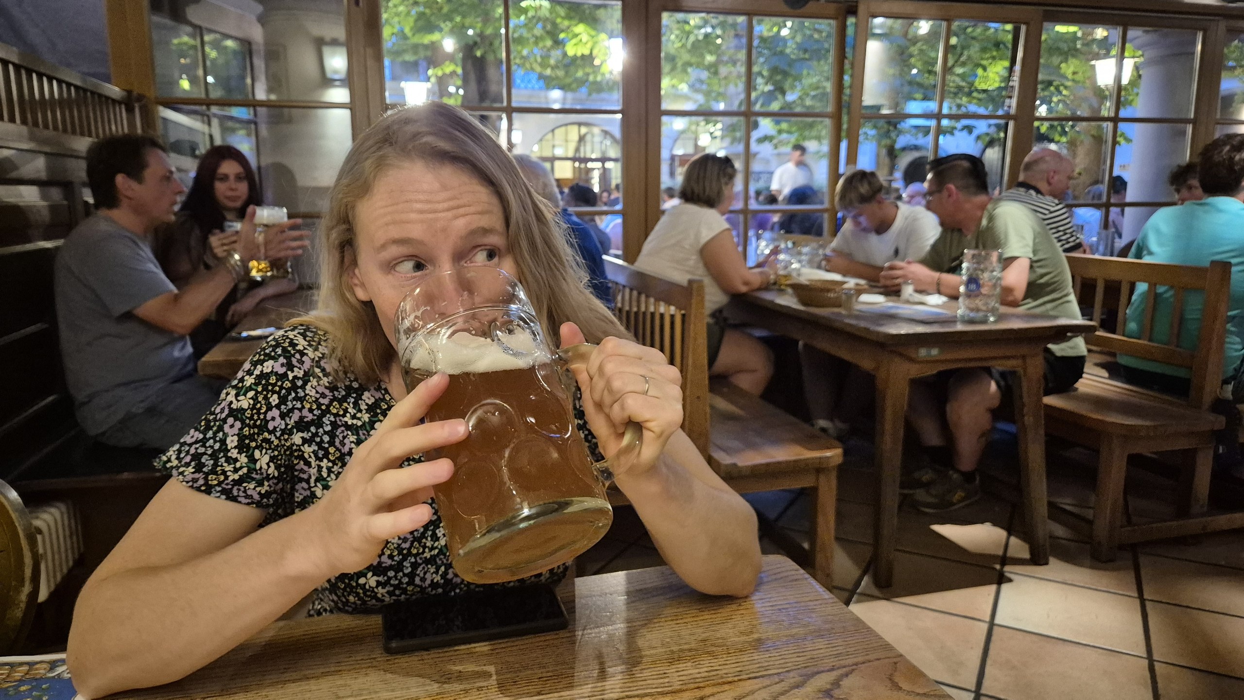 Caro drinking from a one-litre beer stein at the Hofbrauhaus
