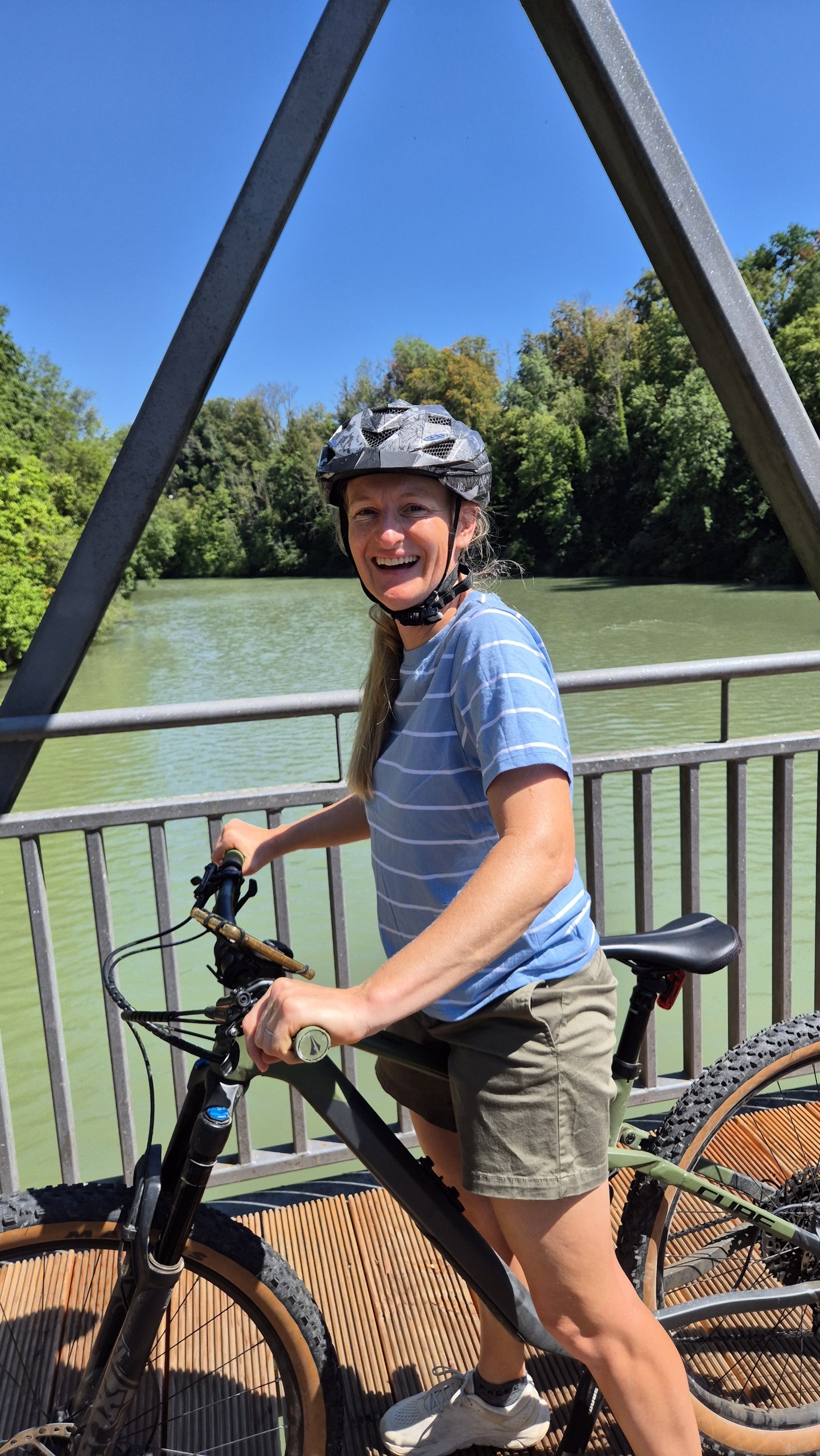 Caro standing with her bicycle on a bridge over the River Iller near Kempten