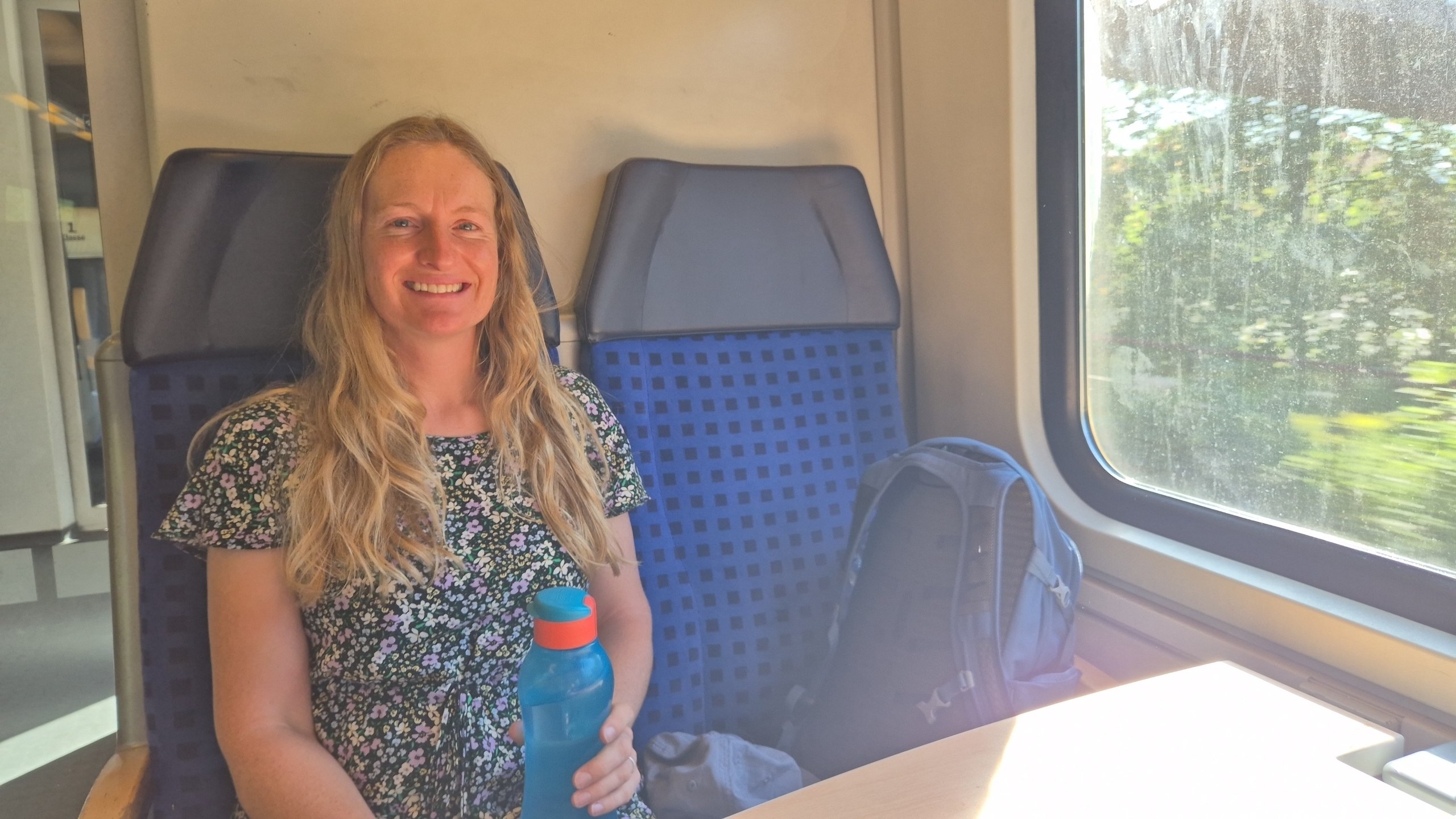 Caro seated on the train from Kempten to Munich