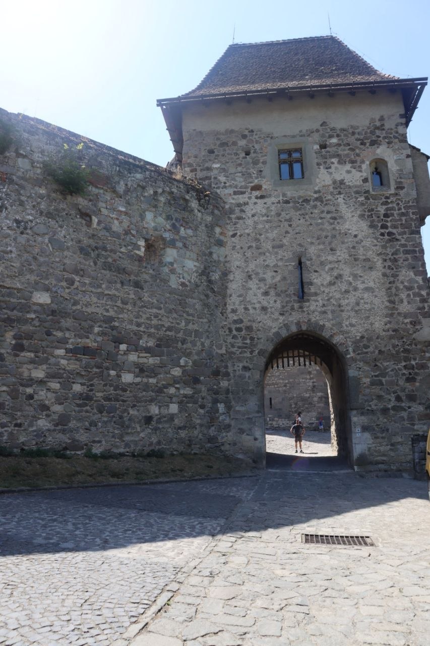 The stone gate and tower of Visegrád Lower Castle in bright afternoon sun