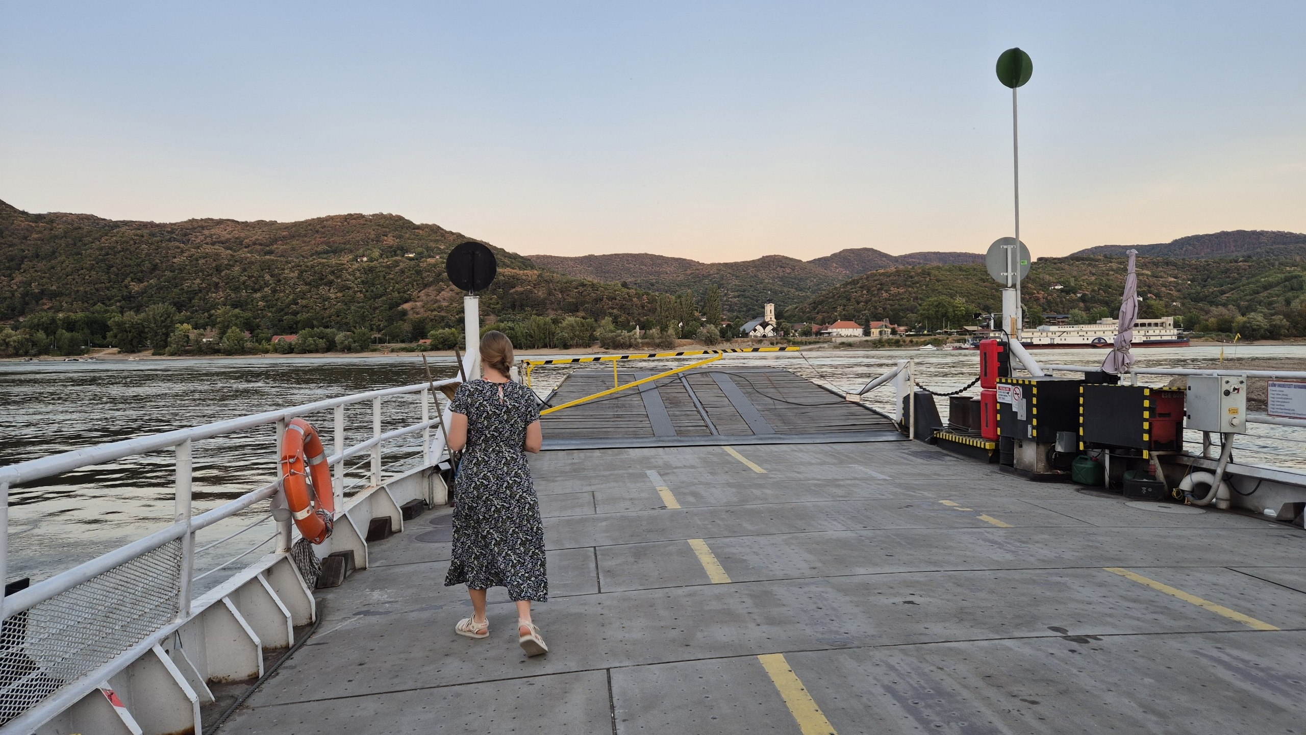 Caro standing on the evening ferry across the Danube to Visegrád
