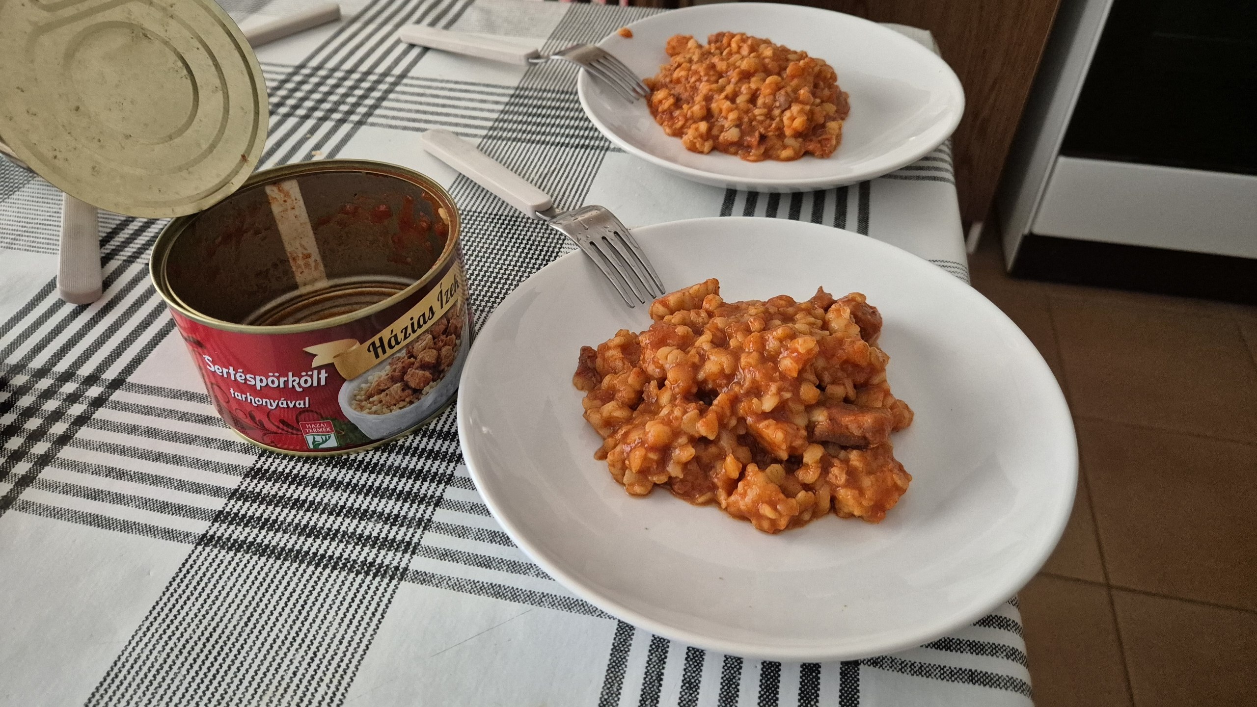 Two plates of pasta with canned Hungarian sertéspörkölt