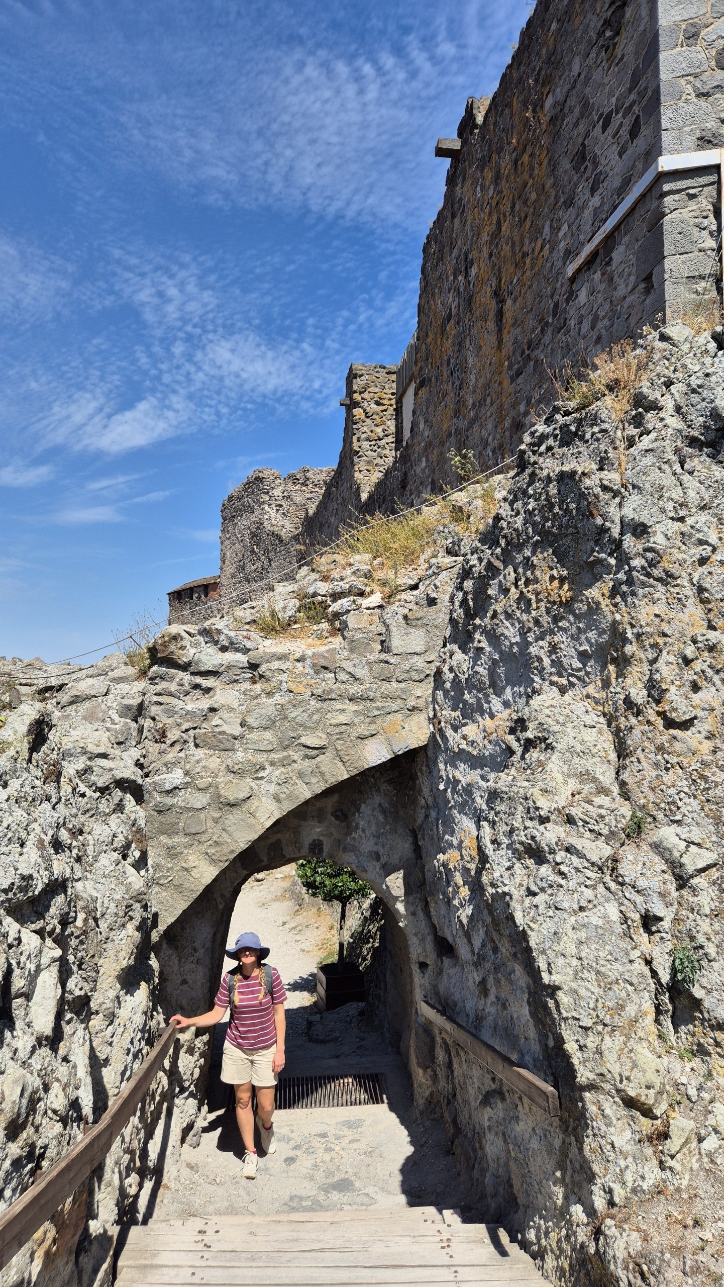 Hugo walking through a stone archway within Visegrád Citadel