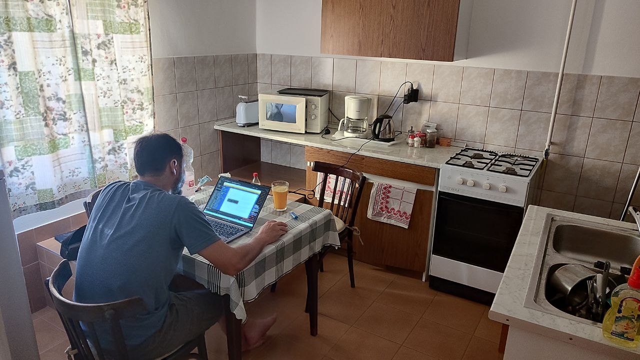 Hugo working at the kitchen table in our Visegrád guesthouse