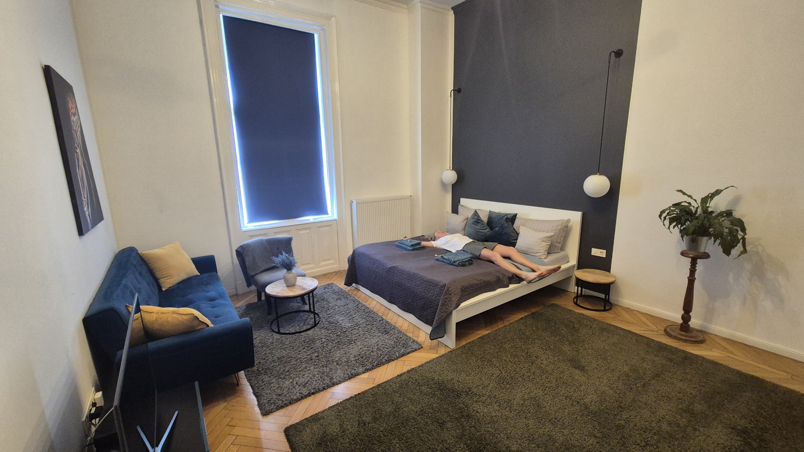 Caro lying on the bed in our spacious Budapest apartment