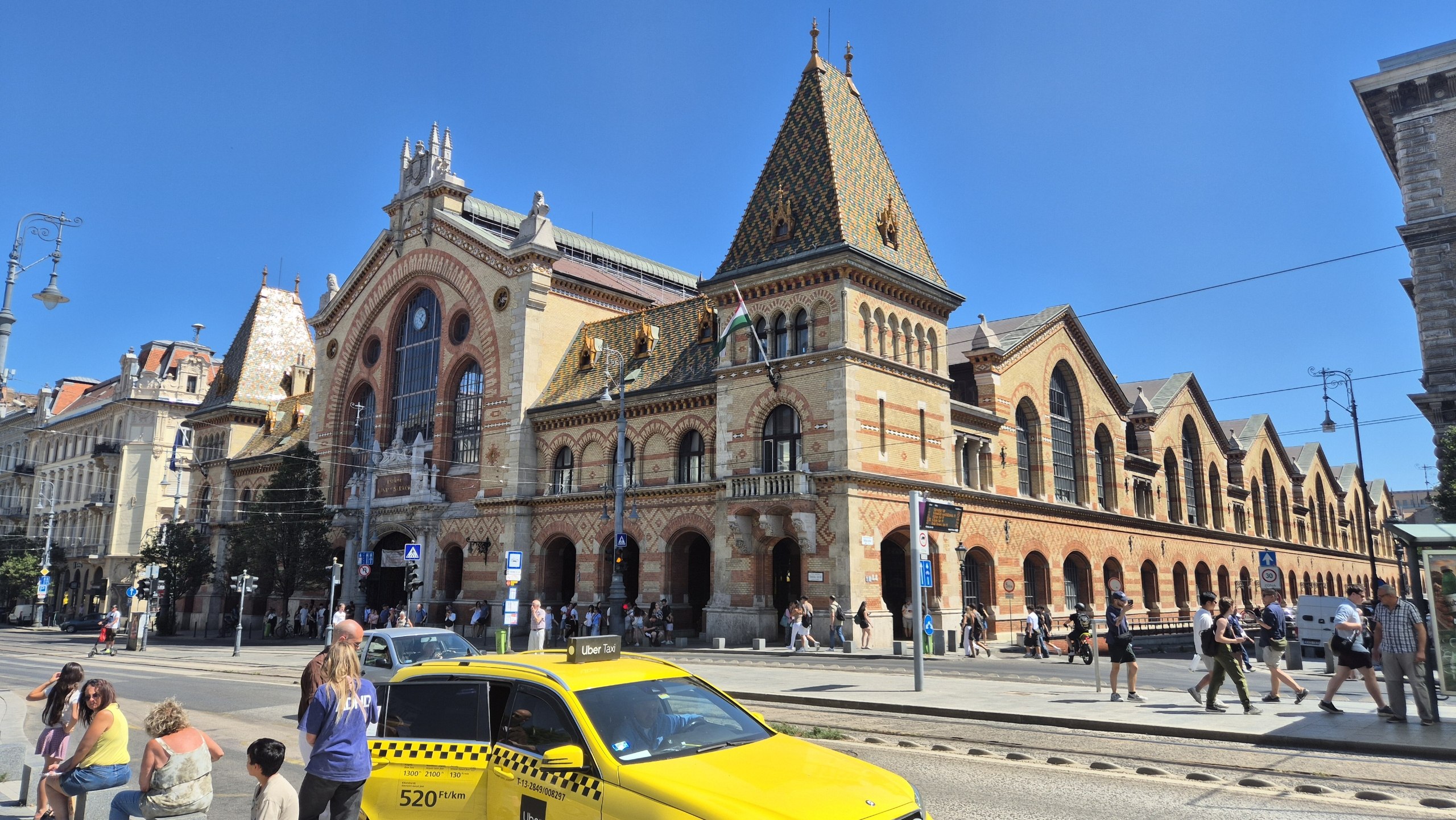 The brick exterior and colourful tiled roof of Budapest Central Market Hall