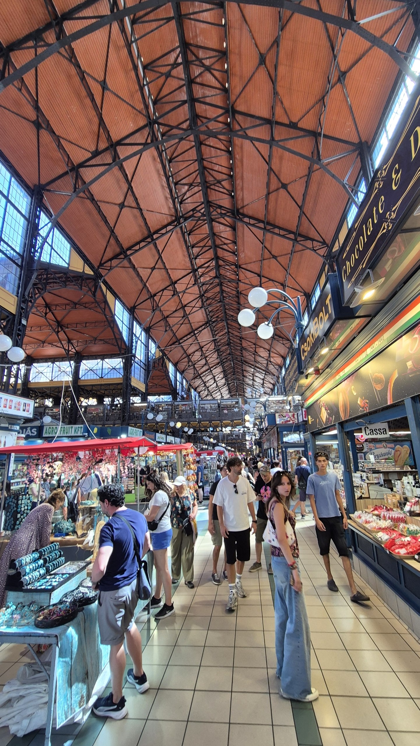 The busy interior of Budapest Central Market Hall beneath its iron roof