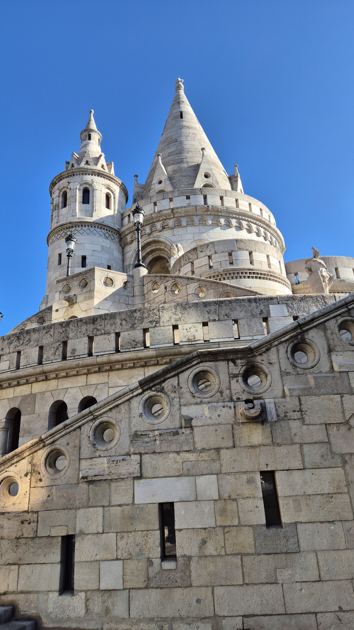 The pale stone turrets of Fisherman's Bastion against a clear blue sky