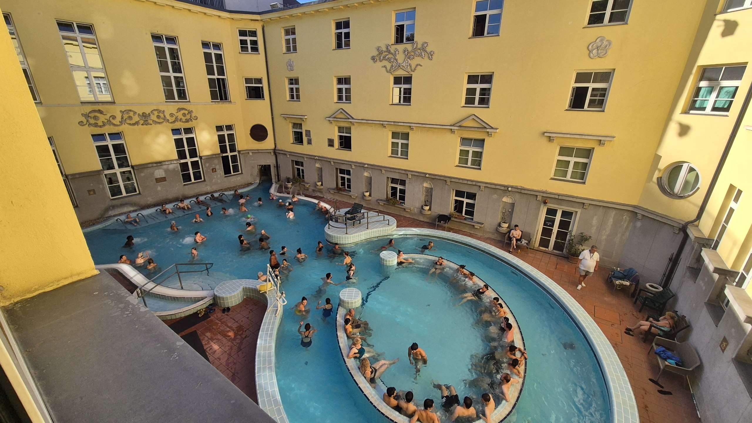 Outdoor thermal pools in the yellow courtyard of Szent Lukács baths