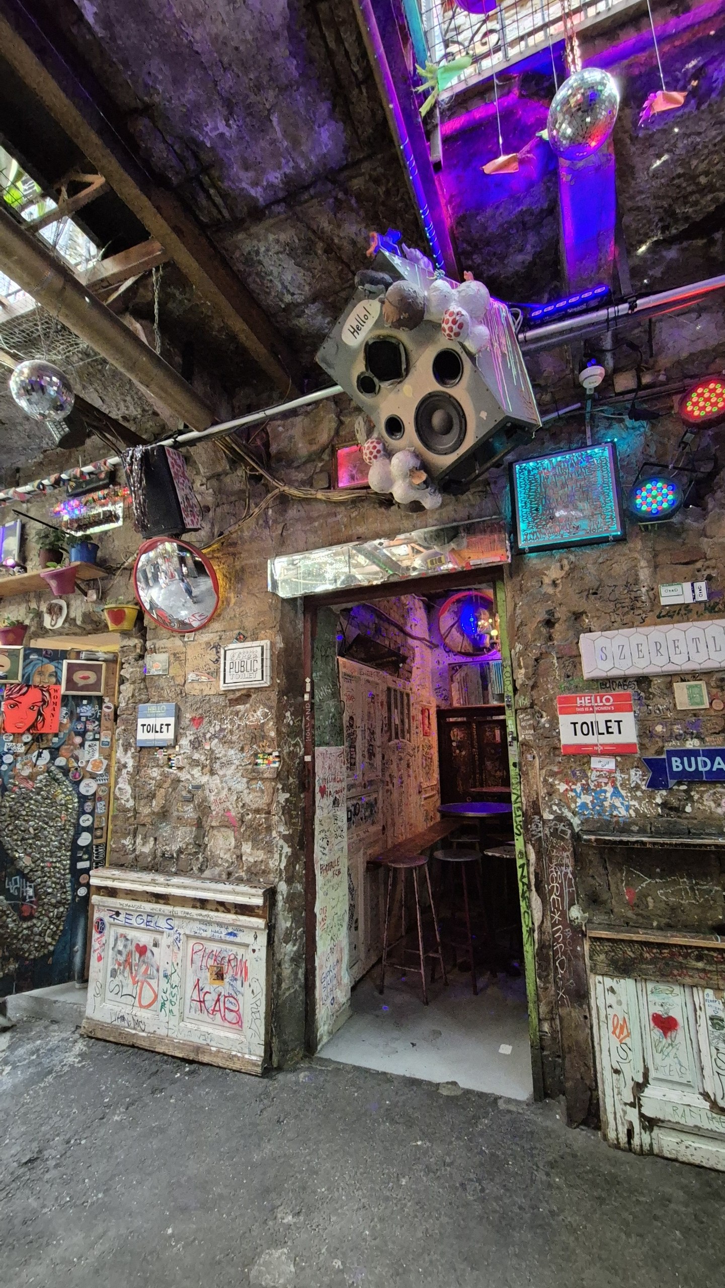 The colourful mismatched interior of Szimpla Kert ruin bar in Budapest
