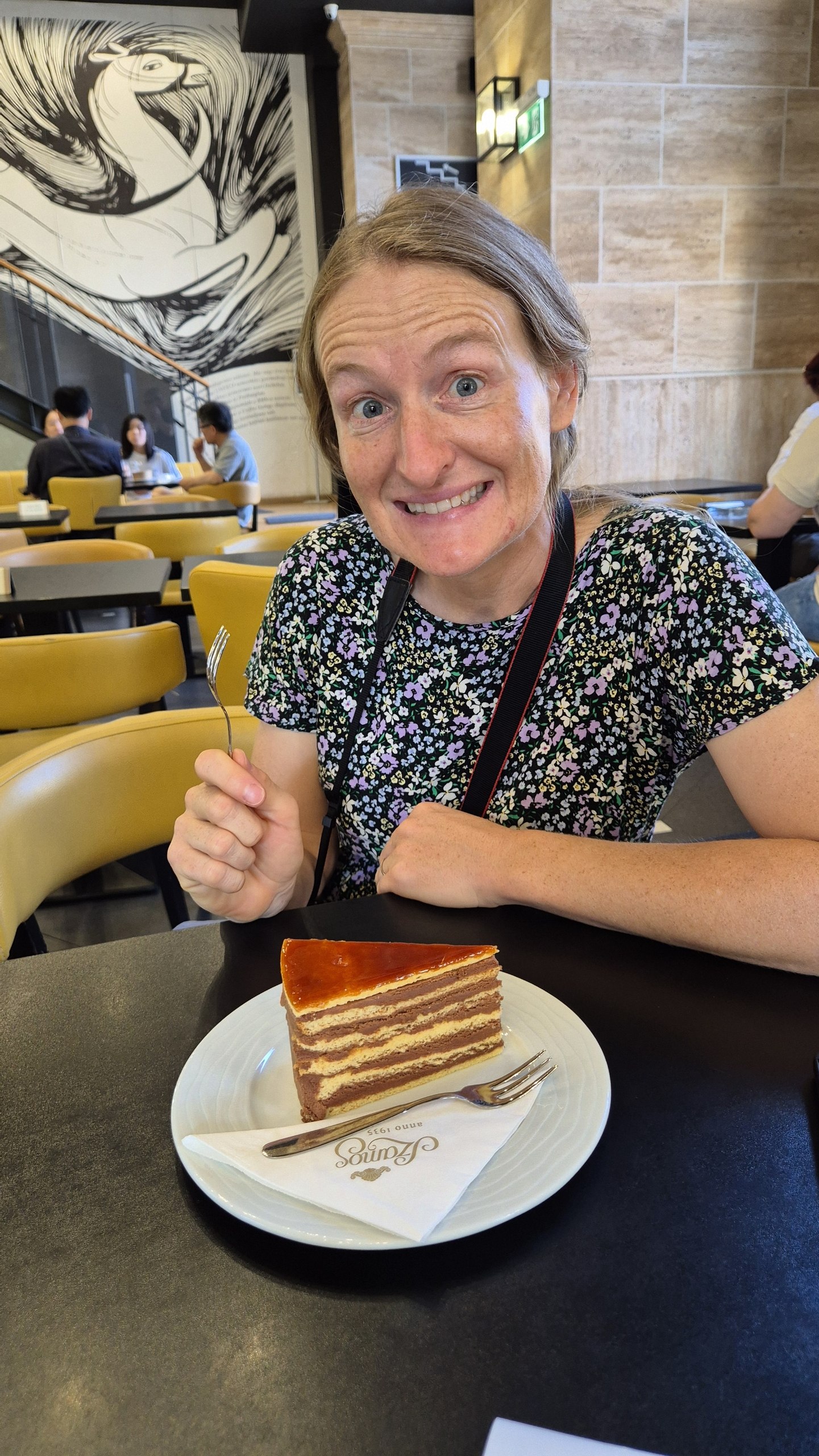 Caro with a slice of Dobos torte in a Budapest cafe
