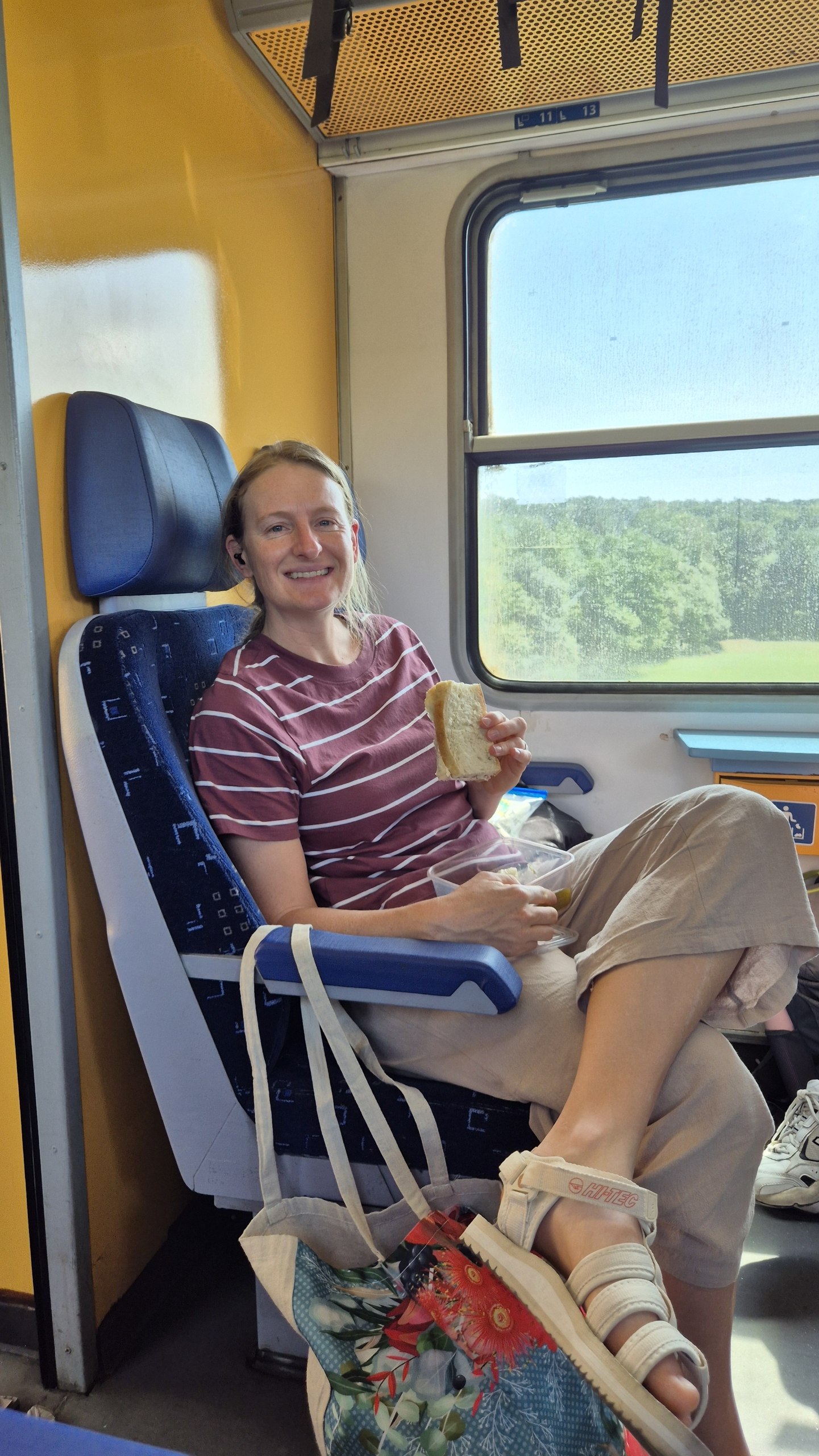 Caro eating a packed sandwich on the train