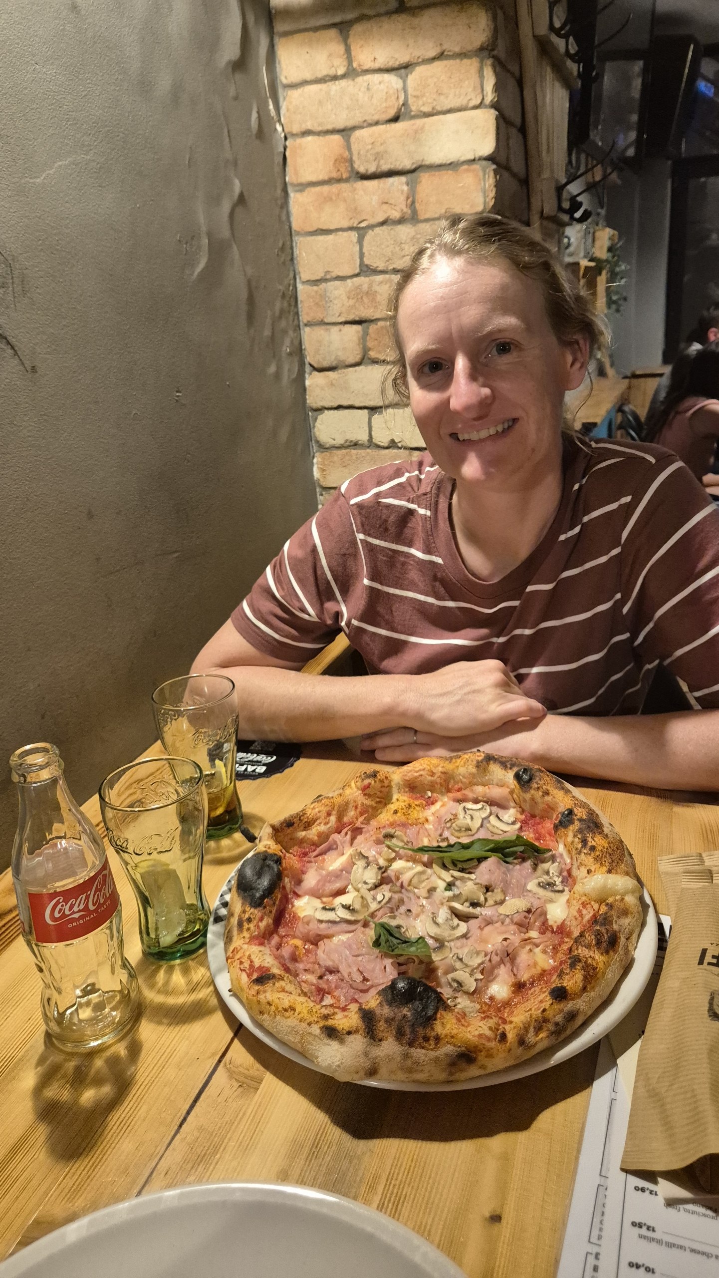 Caro with a pizza at Baffi House of Pizza near Radovljica