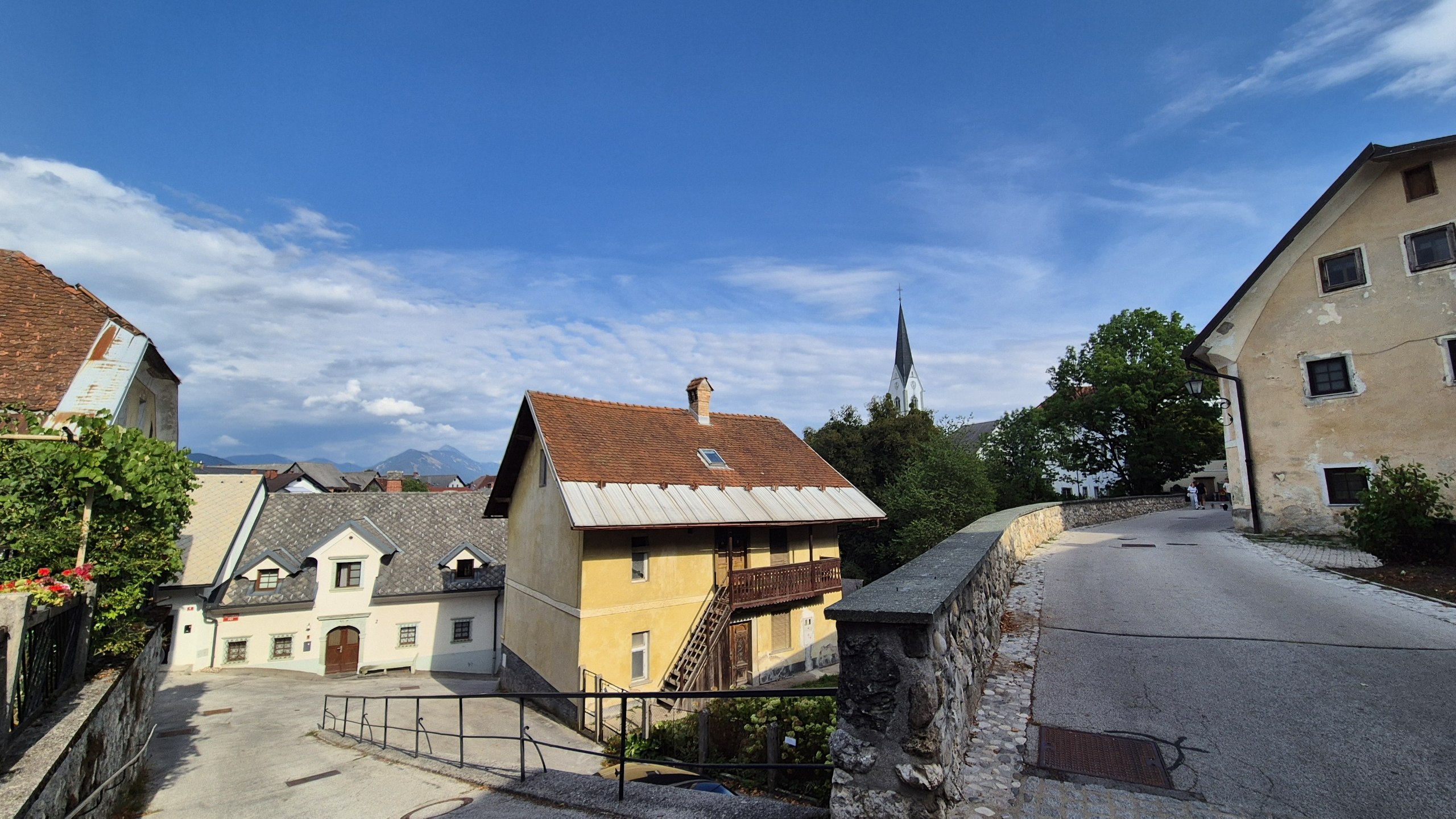 Old houses and a church spire on an evening walk through Radovljica