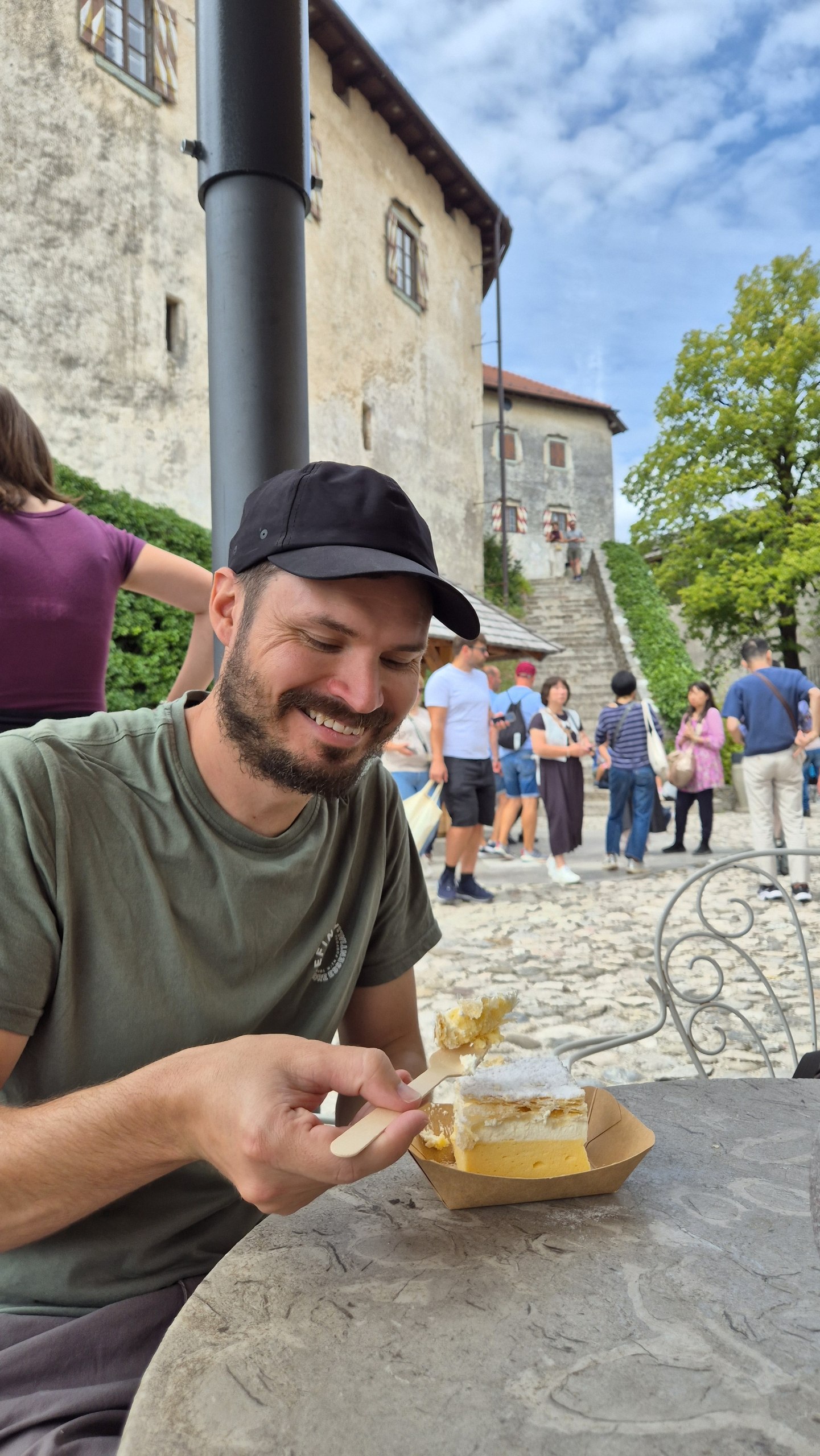 Hugo eating a slice of Bled cream cake at the castle cafe