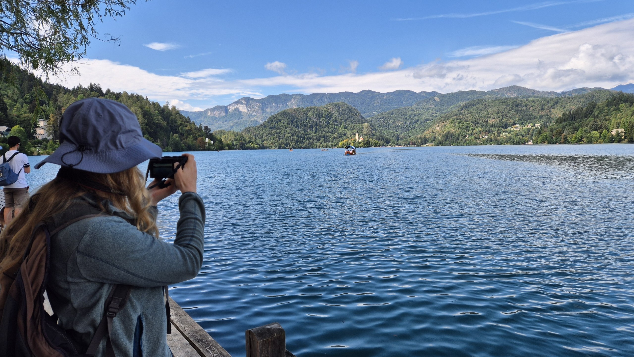 Caro photographing Lake Bled from the shore