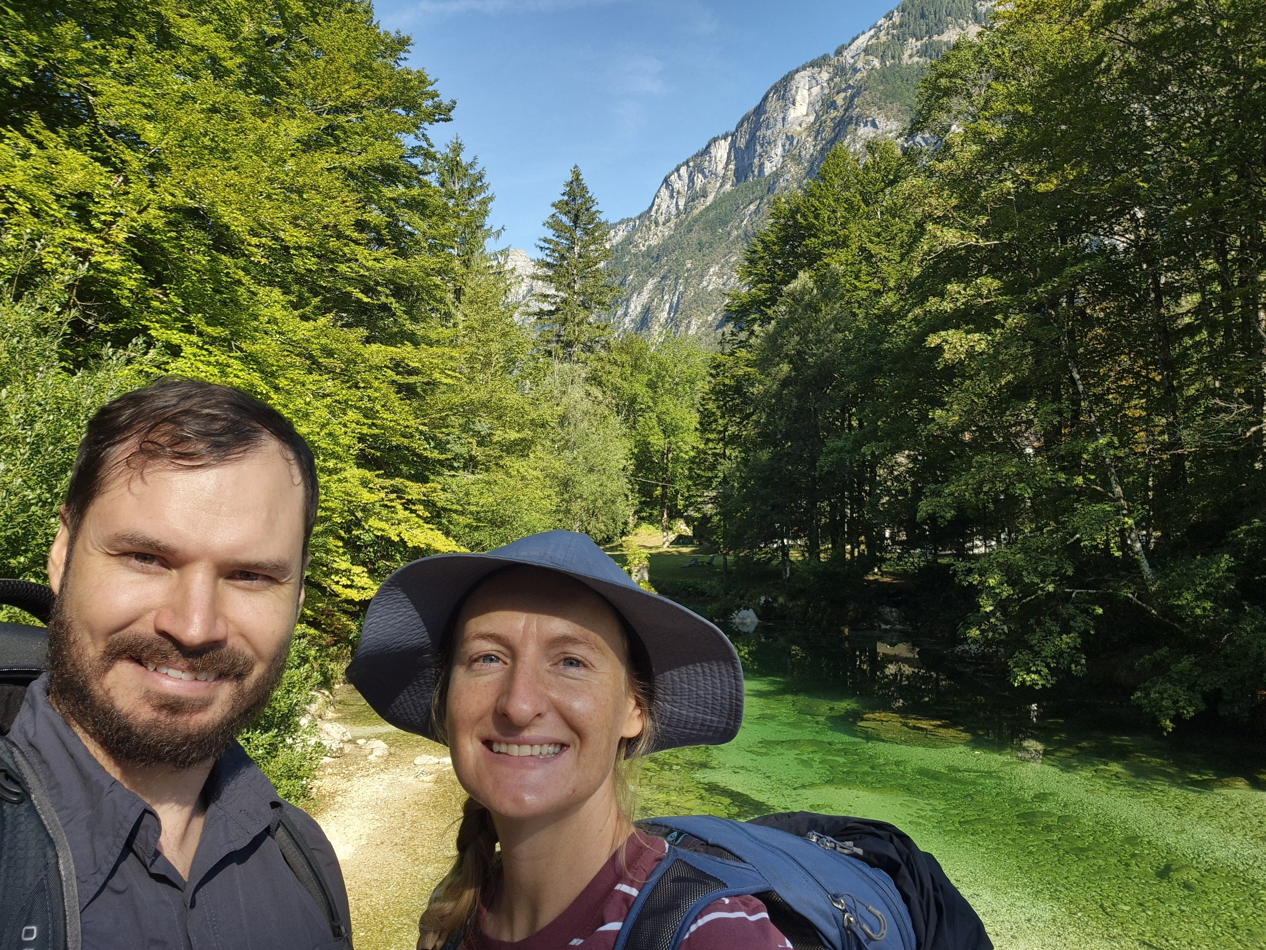 Hugo and Caro at the start of the hike beside clear Alpine water