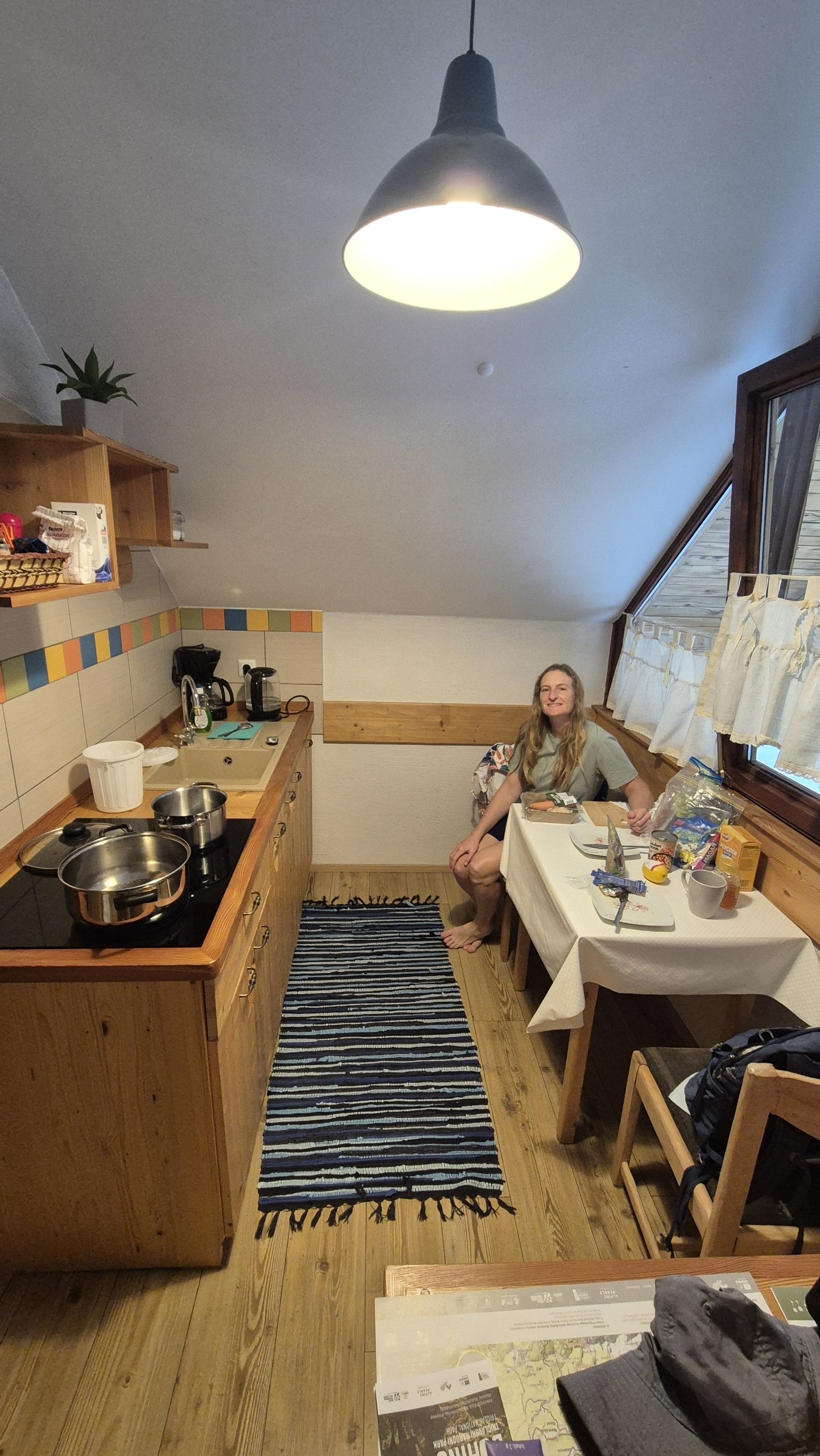 Caro sitting in the compact kitchen of the rooftop apartment