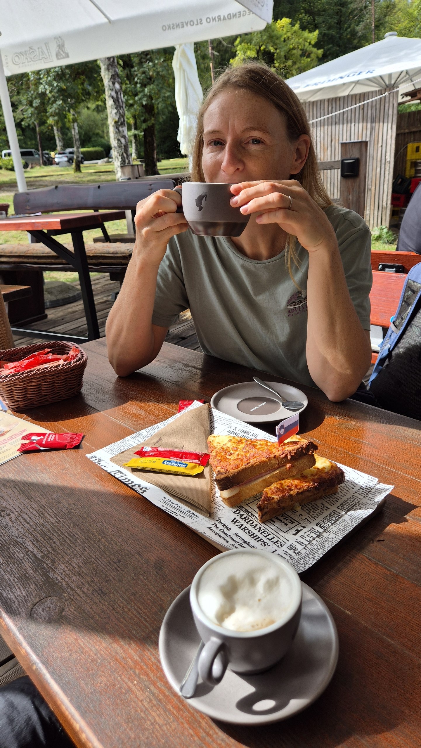 Caro having coffee and a toasted sandwich near Lake Bohinj