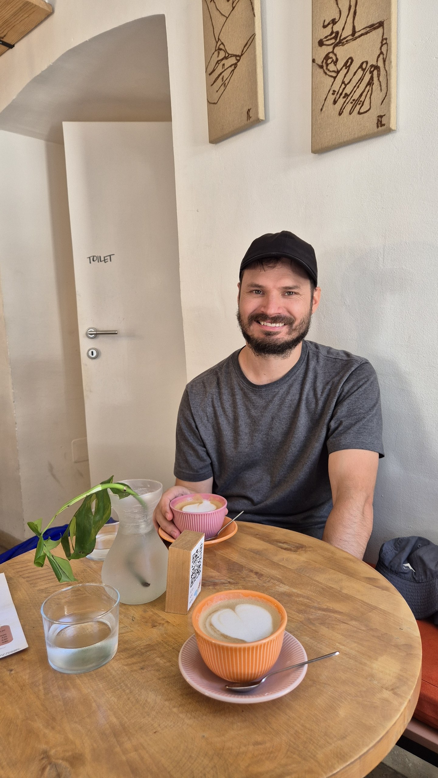 Hugo with two plant-milk coffees at a cafe in Zagreb