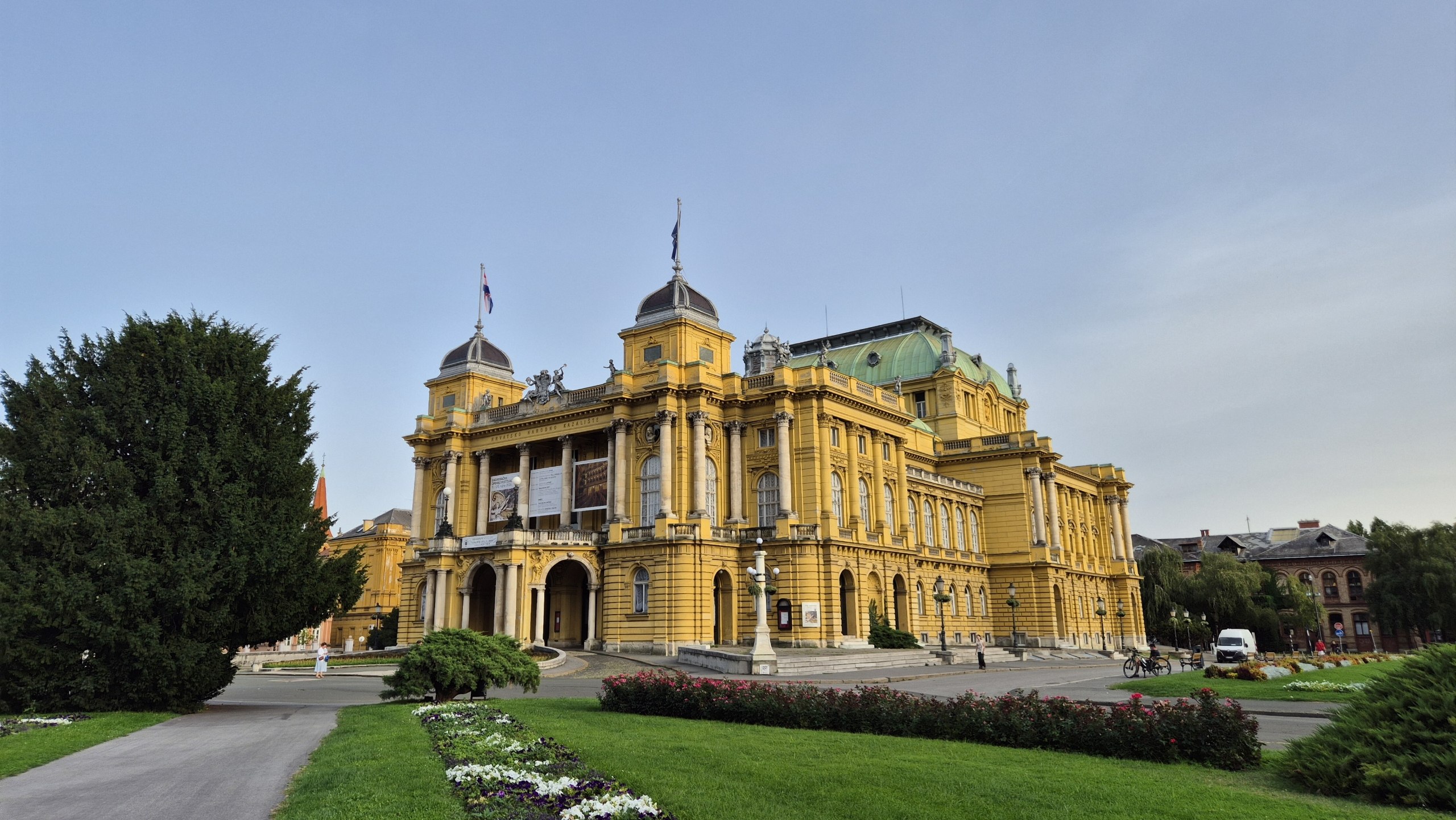 The yellow Croatian National Theatre building in Zagreb at dusk