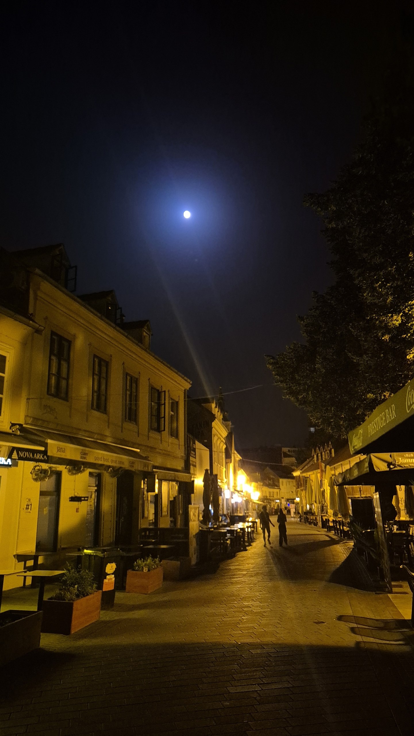 The moon above a quiet street in Zagreb after midnight