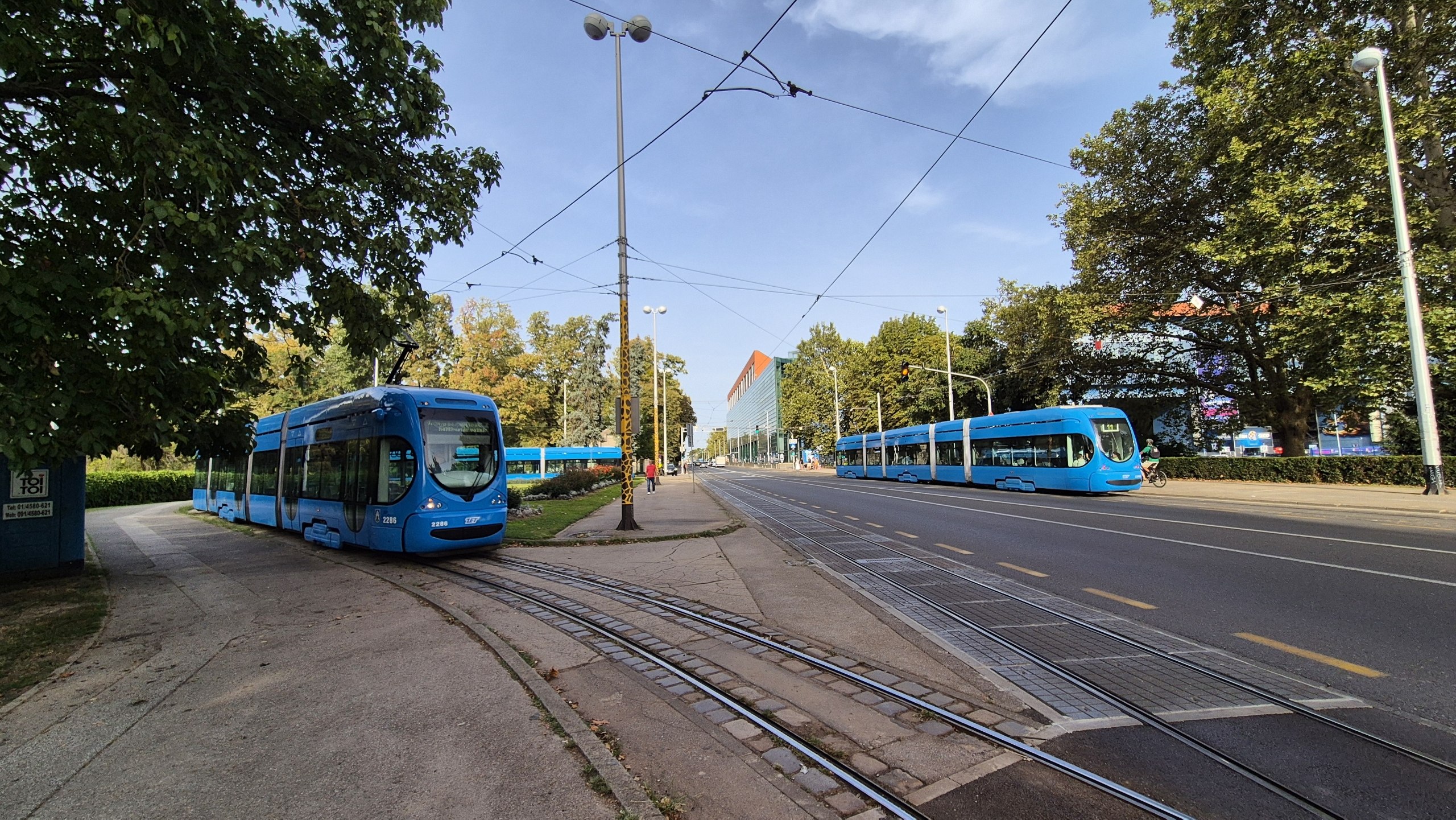 Blue Zagreb trams beside the entrance to Maksimir Park