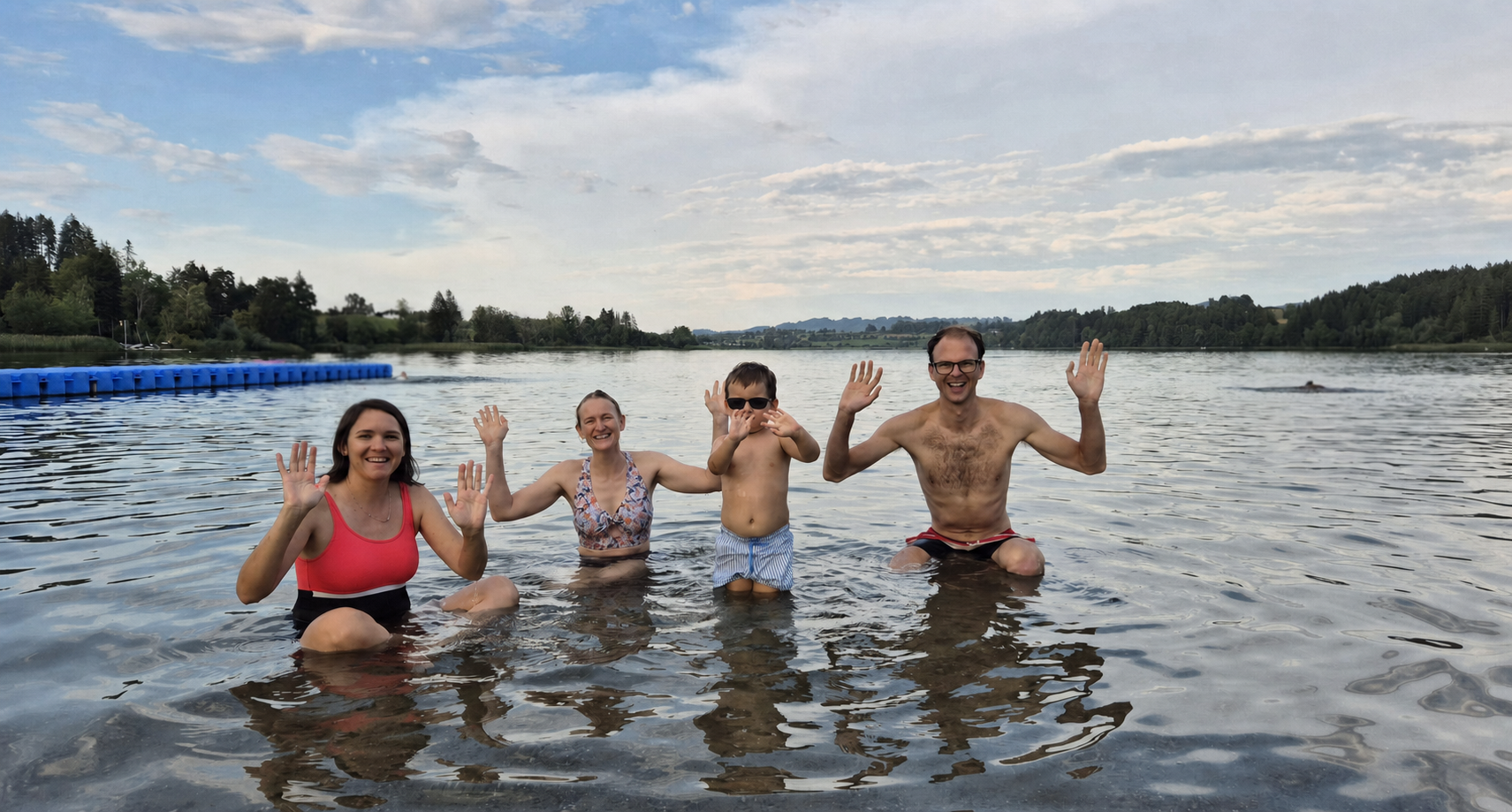 Hugo, Caro and the Kraemers swimming in the Niedersonthofener See, with sunglasses covering the child’s eyes