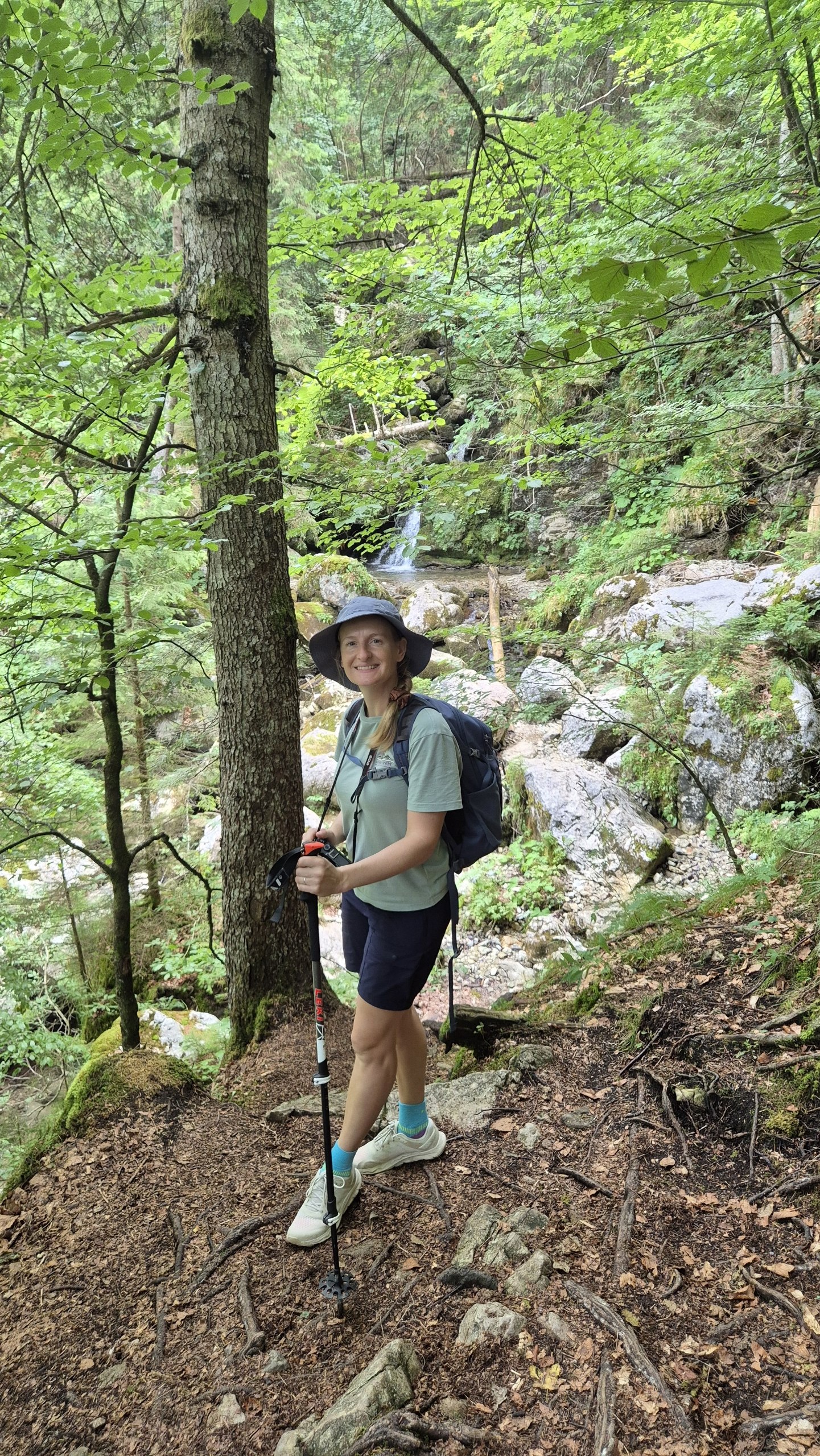 Caro hiking beside a small forest stream