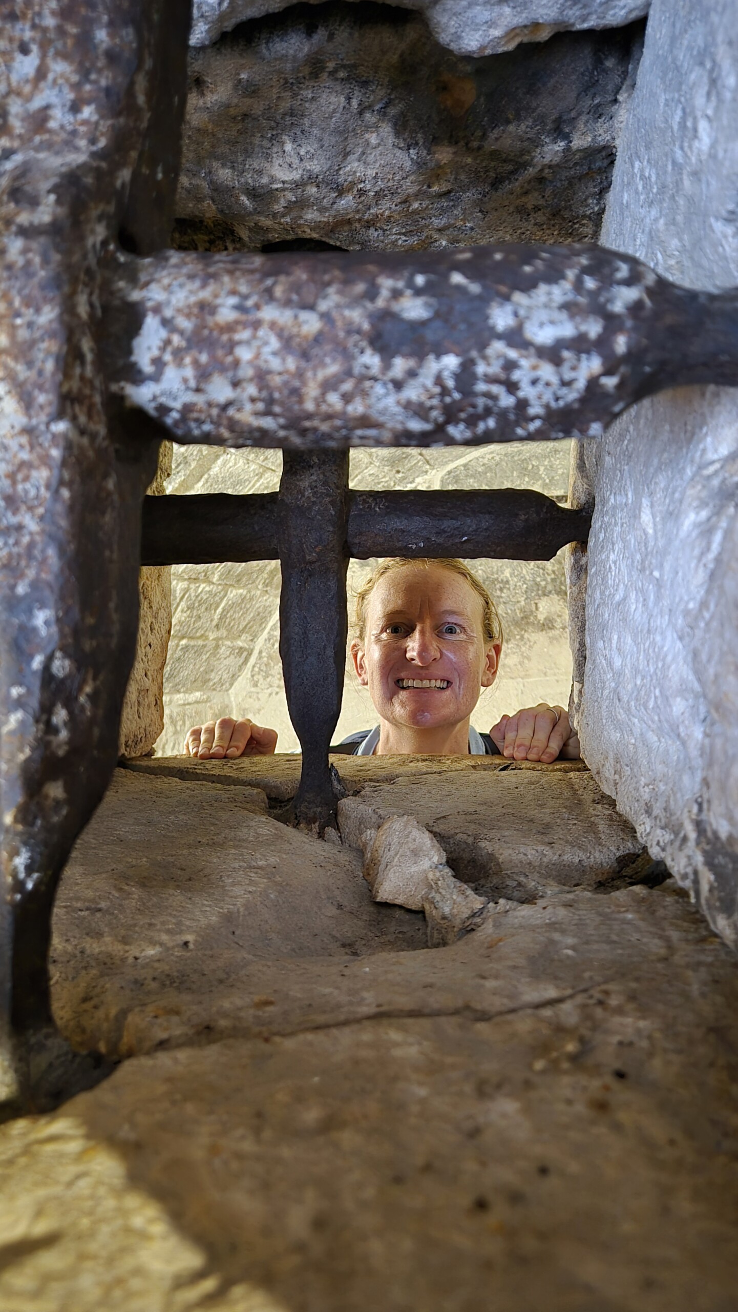 20260911_125553 Caro looking through an old iron grille in Dubrovnik