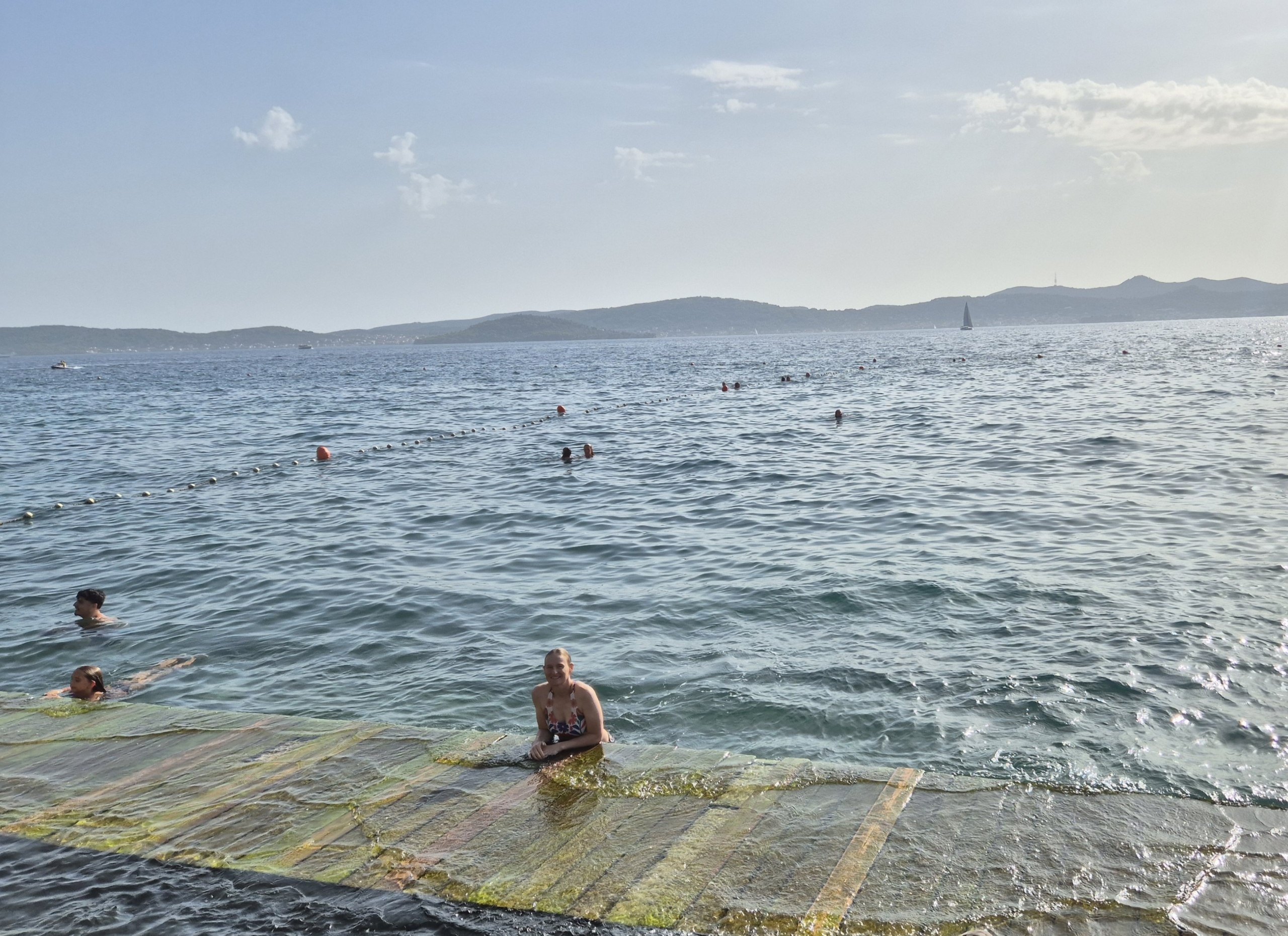 Hugo and Caro swimming in the Adriatic beside a concrete bathing platform in Zadar