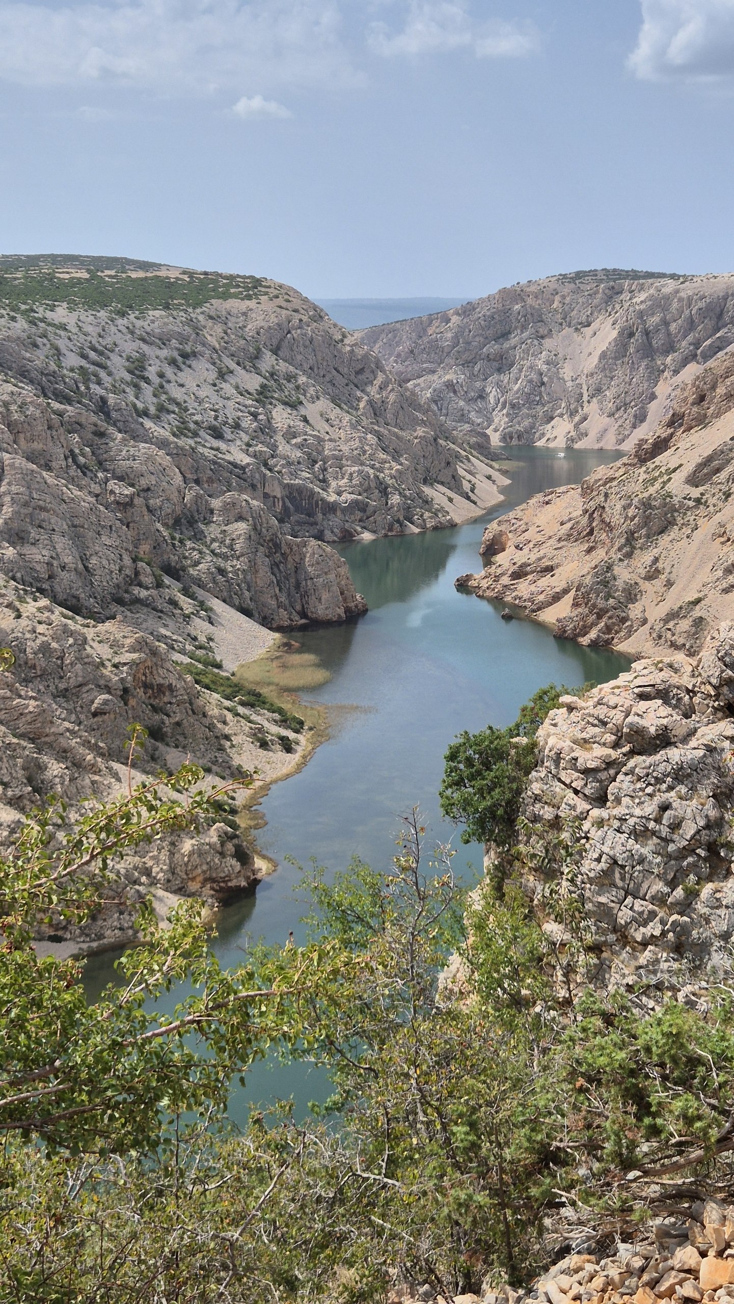 The green-blue Zrmanja River winding between steep limestone walls