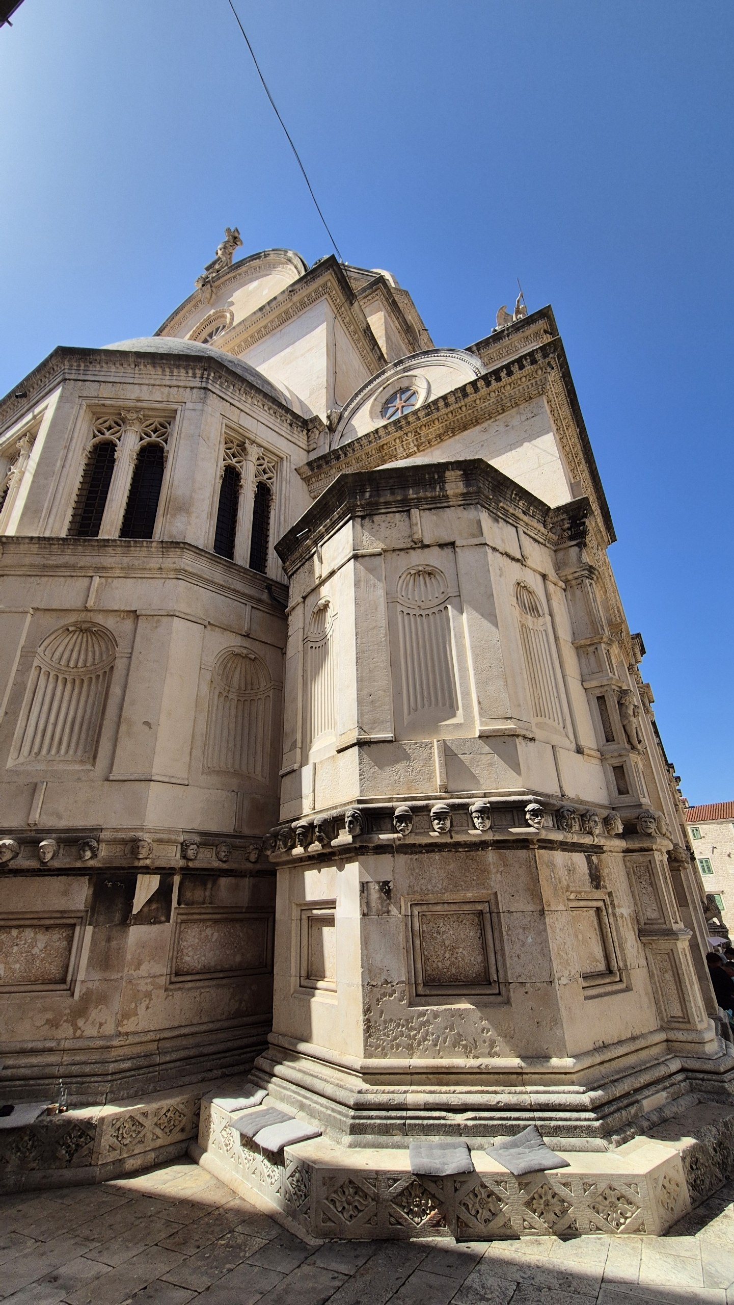 Stone apses and part of the frieze of sculpted faces on the Cathedral of St James