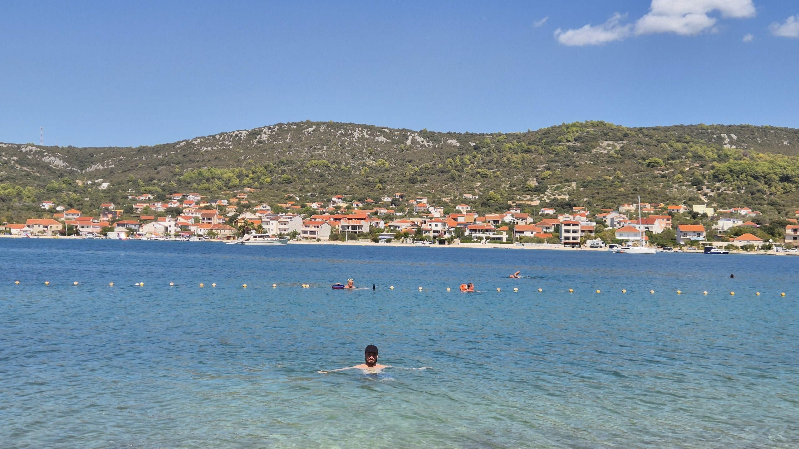 Hugo swimming in the clear blue water at Plaža Smokvina