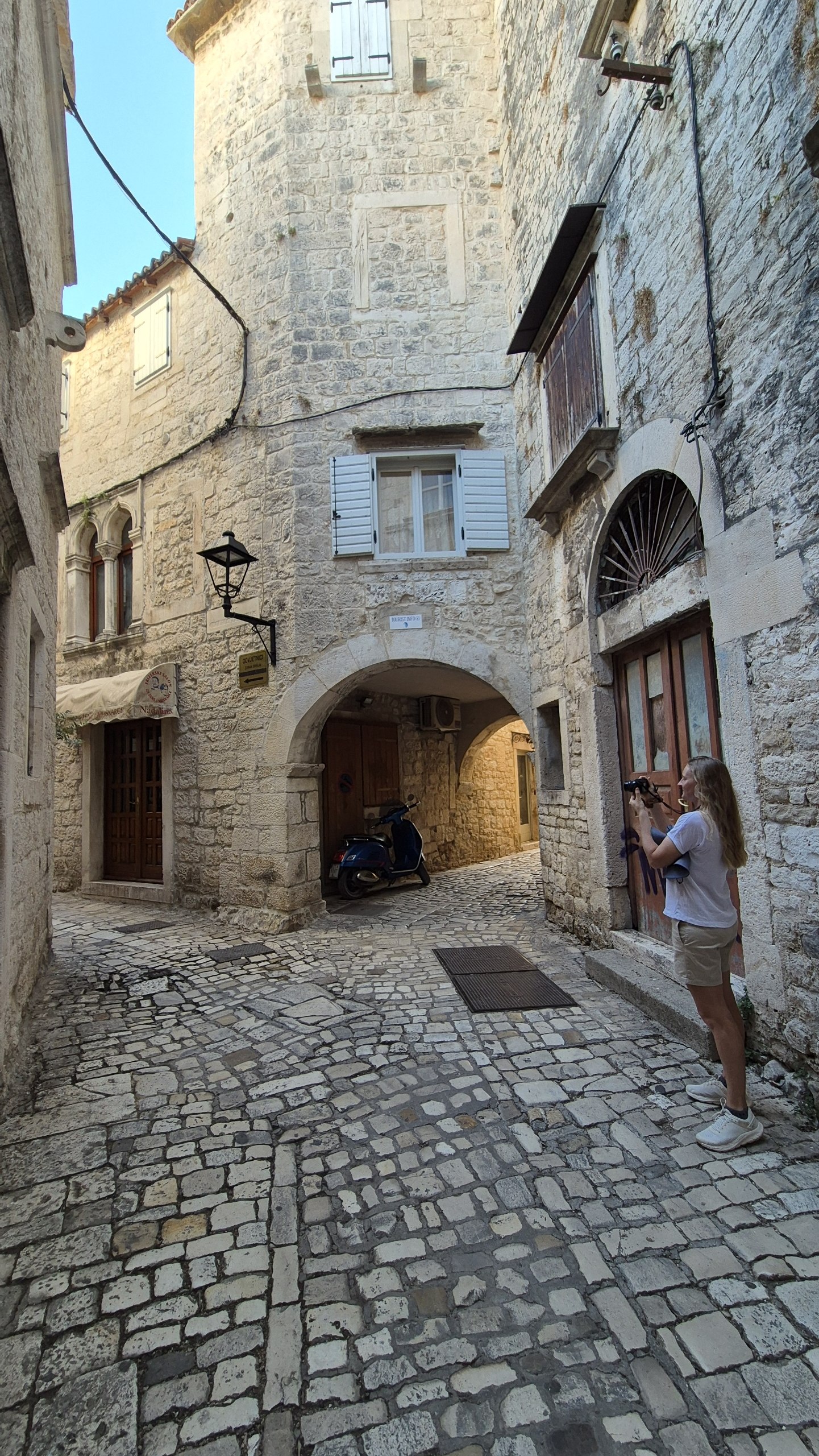 Caro photographing one of Trogir's narrow cobbled streets