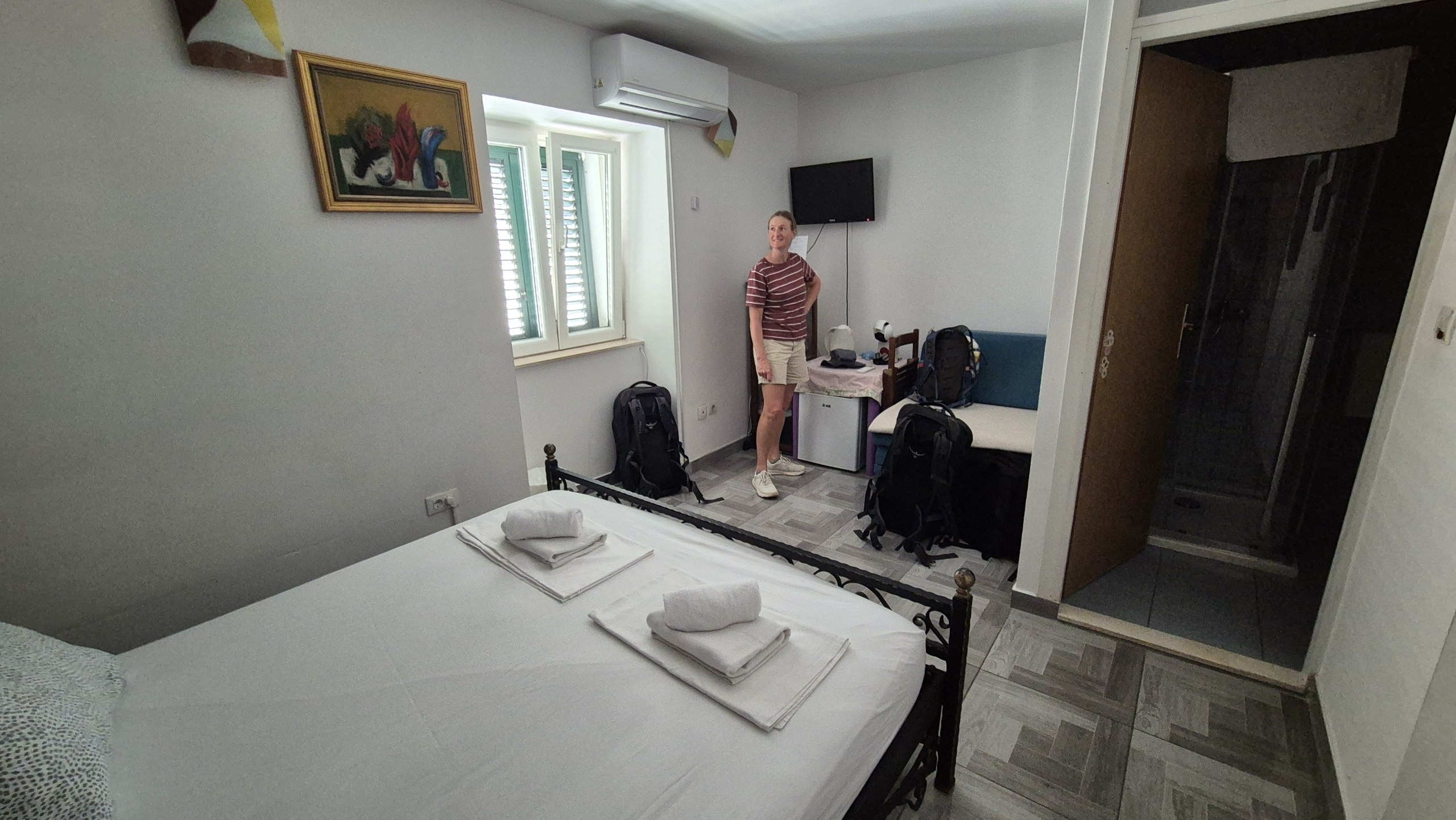 Caro standing in the small room in Split with the backpacks unpacked