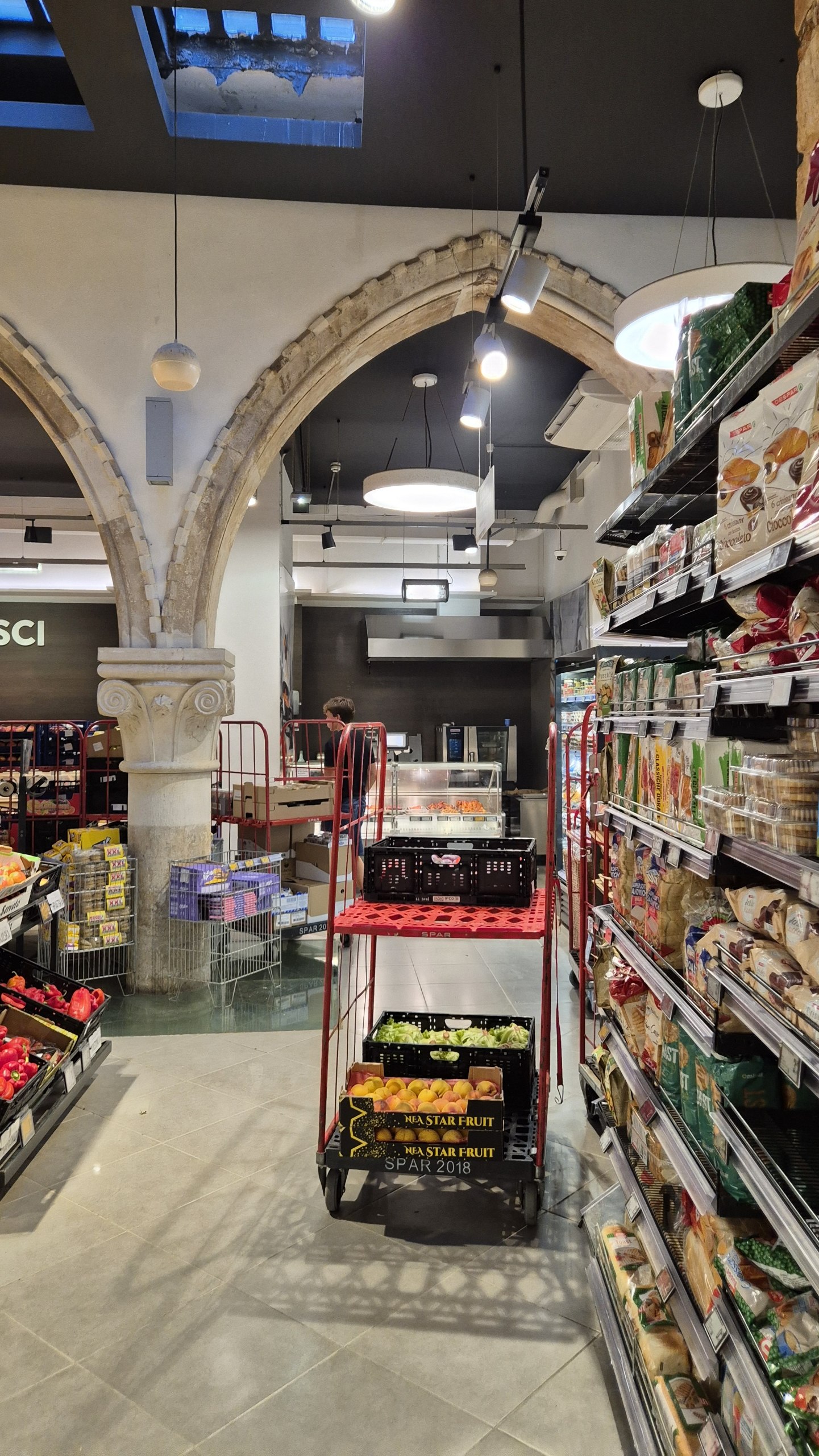 A SPAR grocery store built around old stone arches and columns in Split