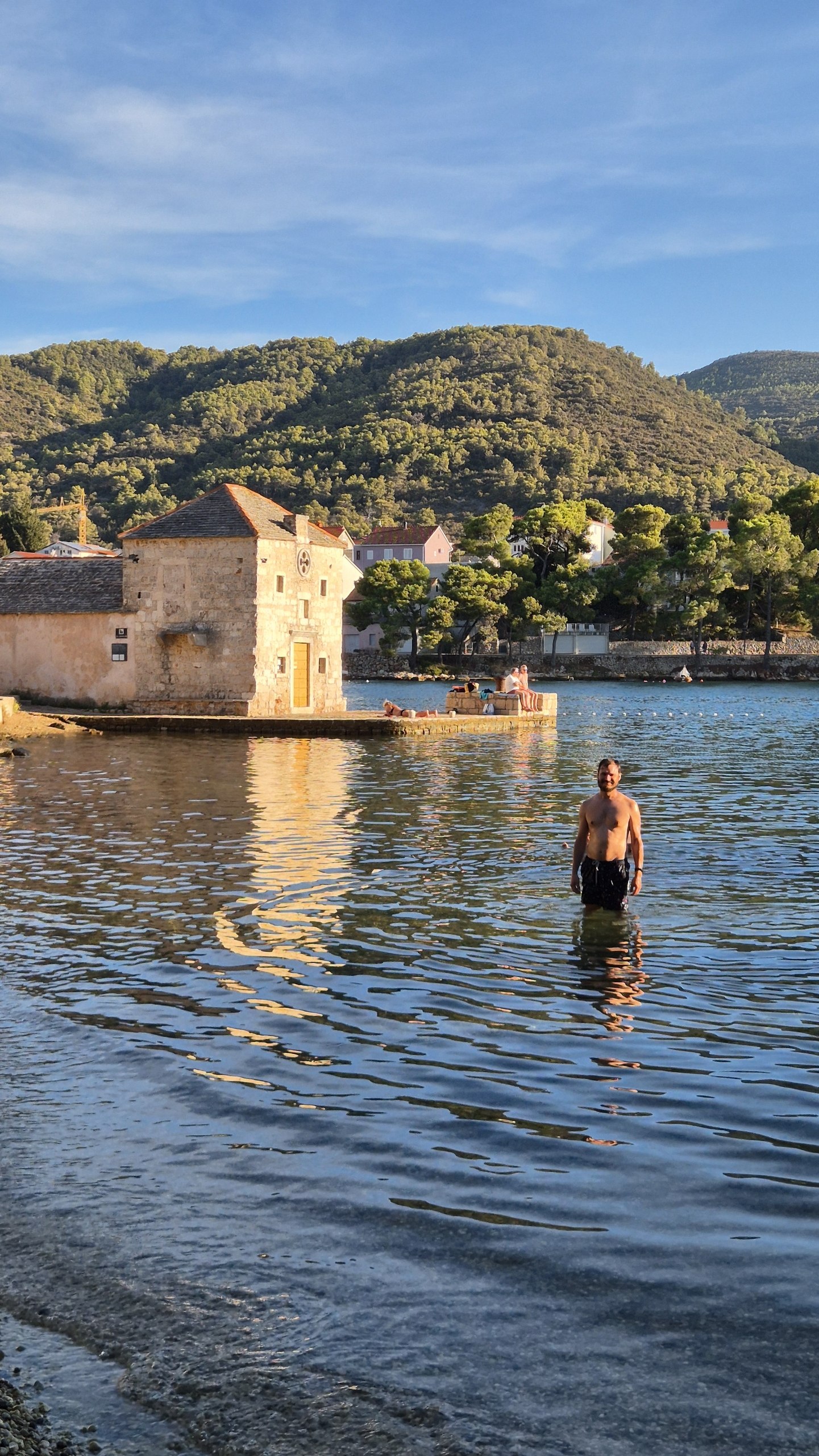 Hugo standing in the sea at the end of Stari Grad harbour