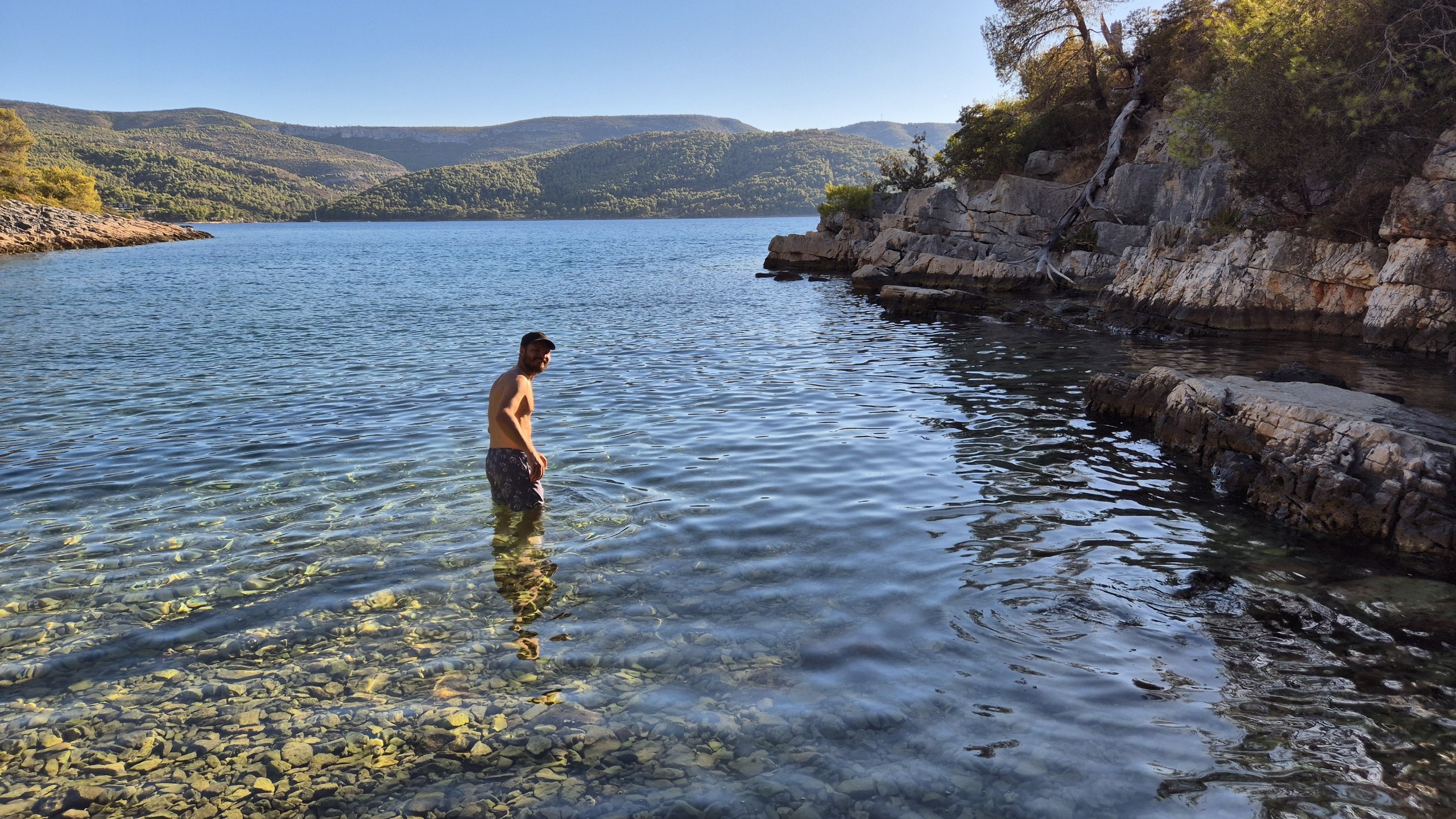 Hugo standing in the clear water at Uvala Zavala