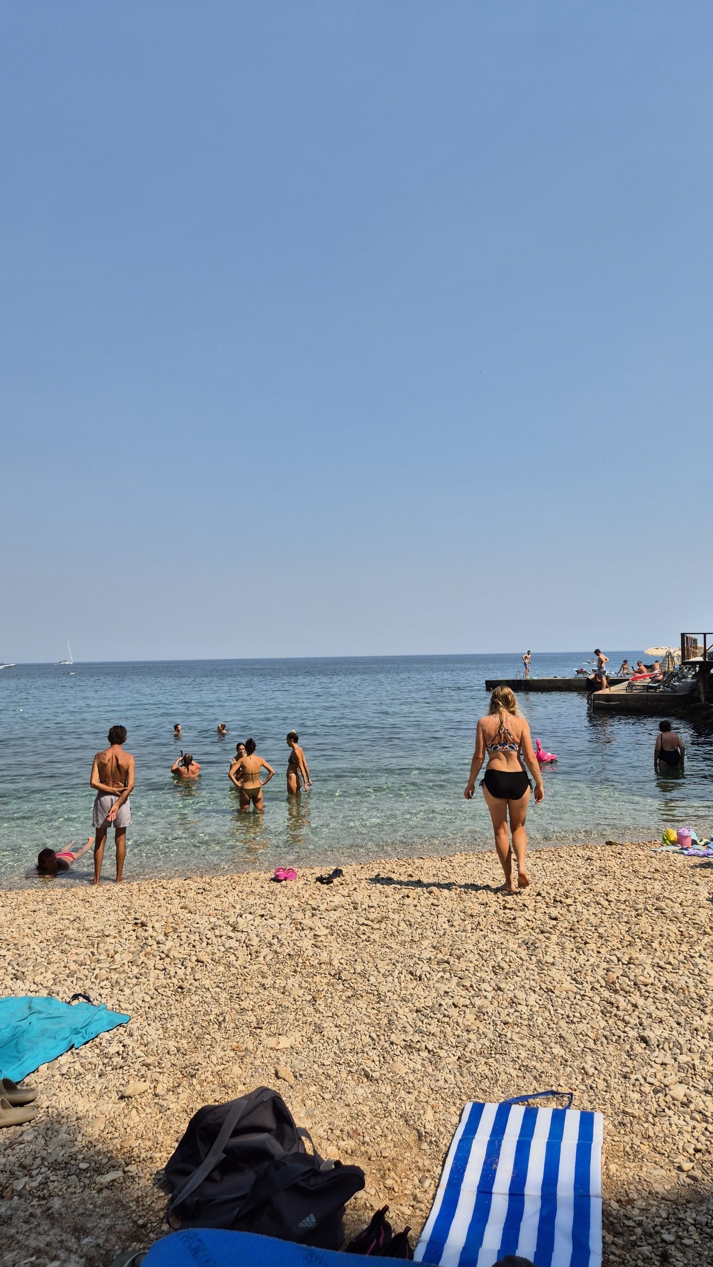 Sunday swimmers filling a small pebble beach on Hvar