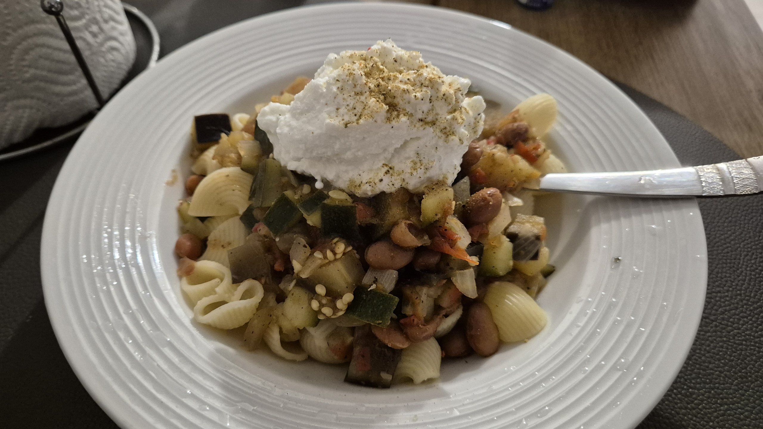 Pasta with vegetables, beans and soft cheese for an early dinner in Mlini