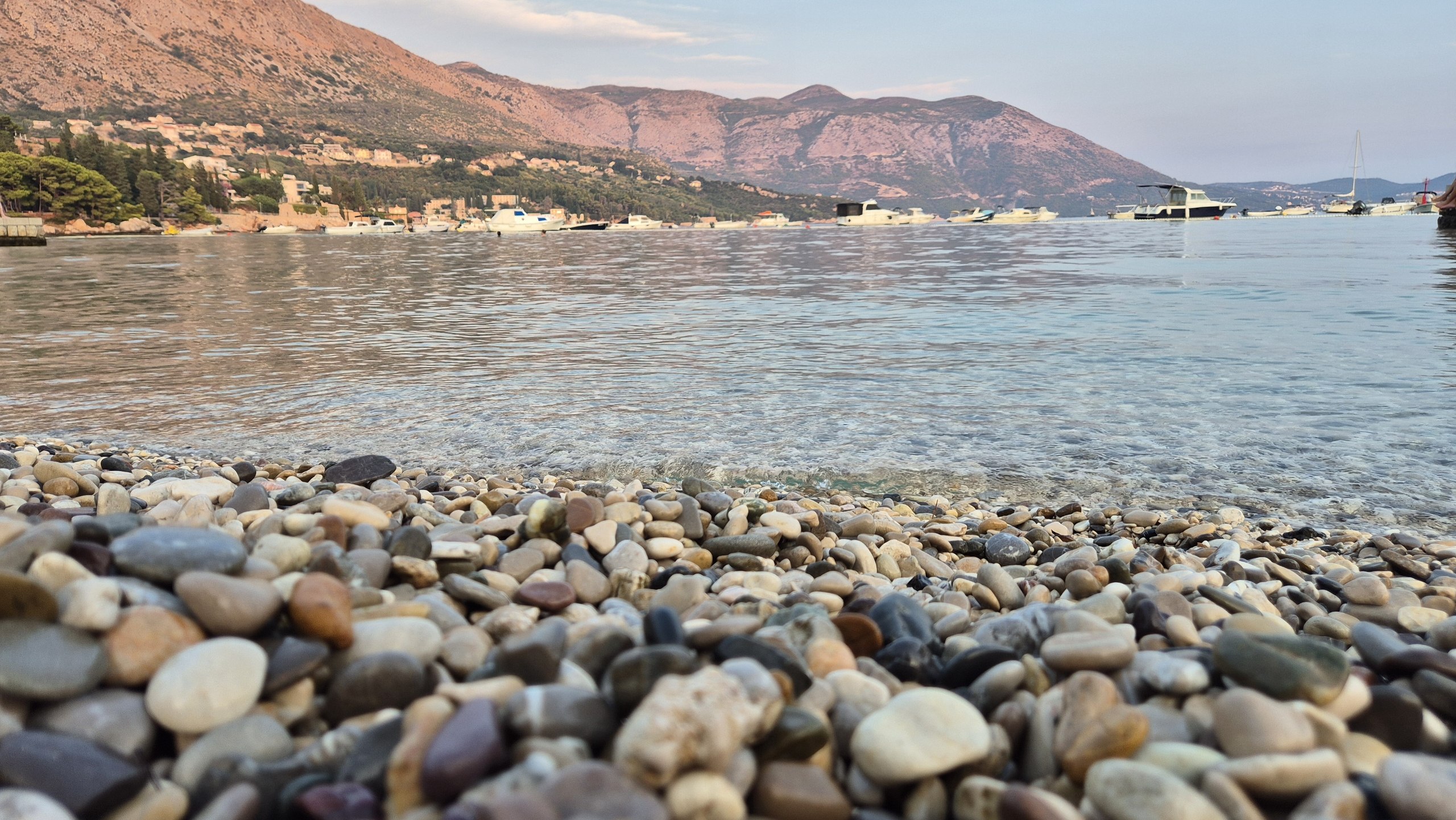 Smooth pebbles and clear water at the beach in Mlini
