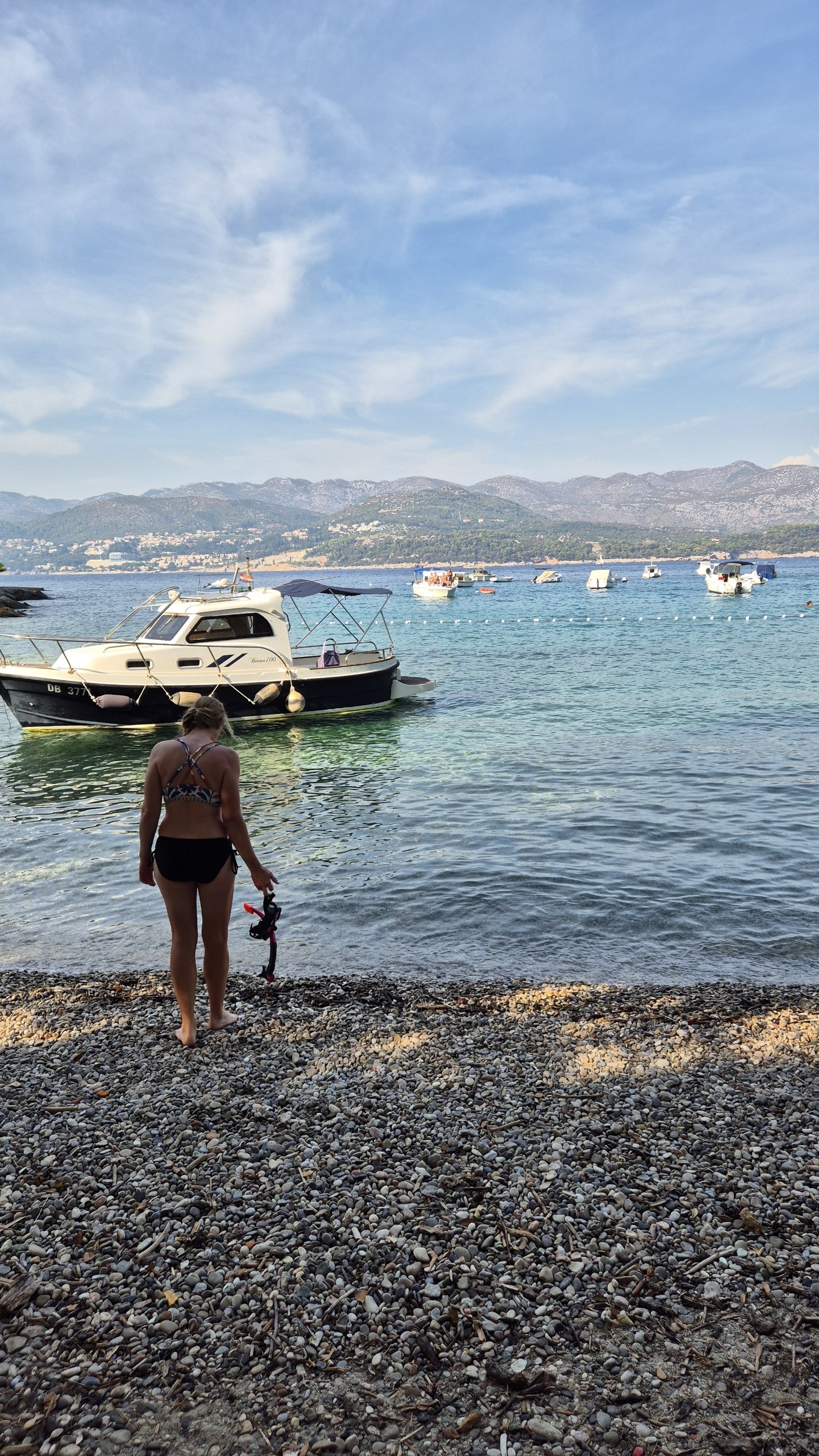 Caro entering the water at the quiet final cove on Kolocep