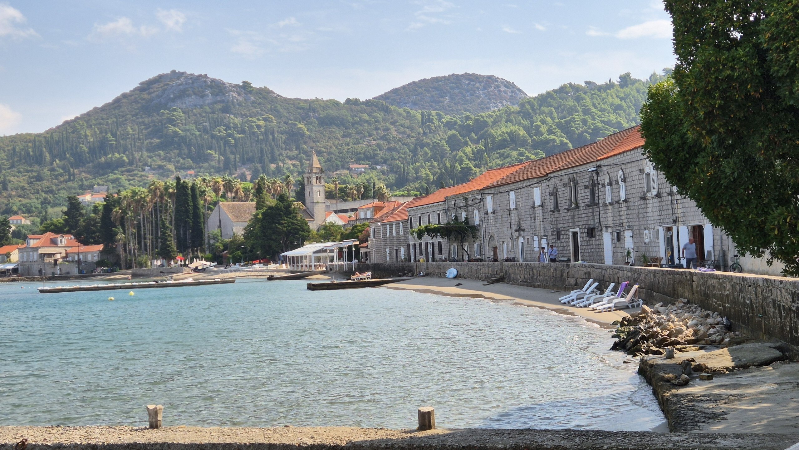 Stone houses and a small beach along the Lopud waterfront