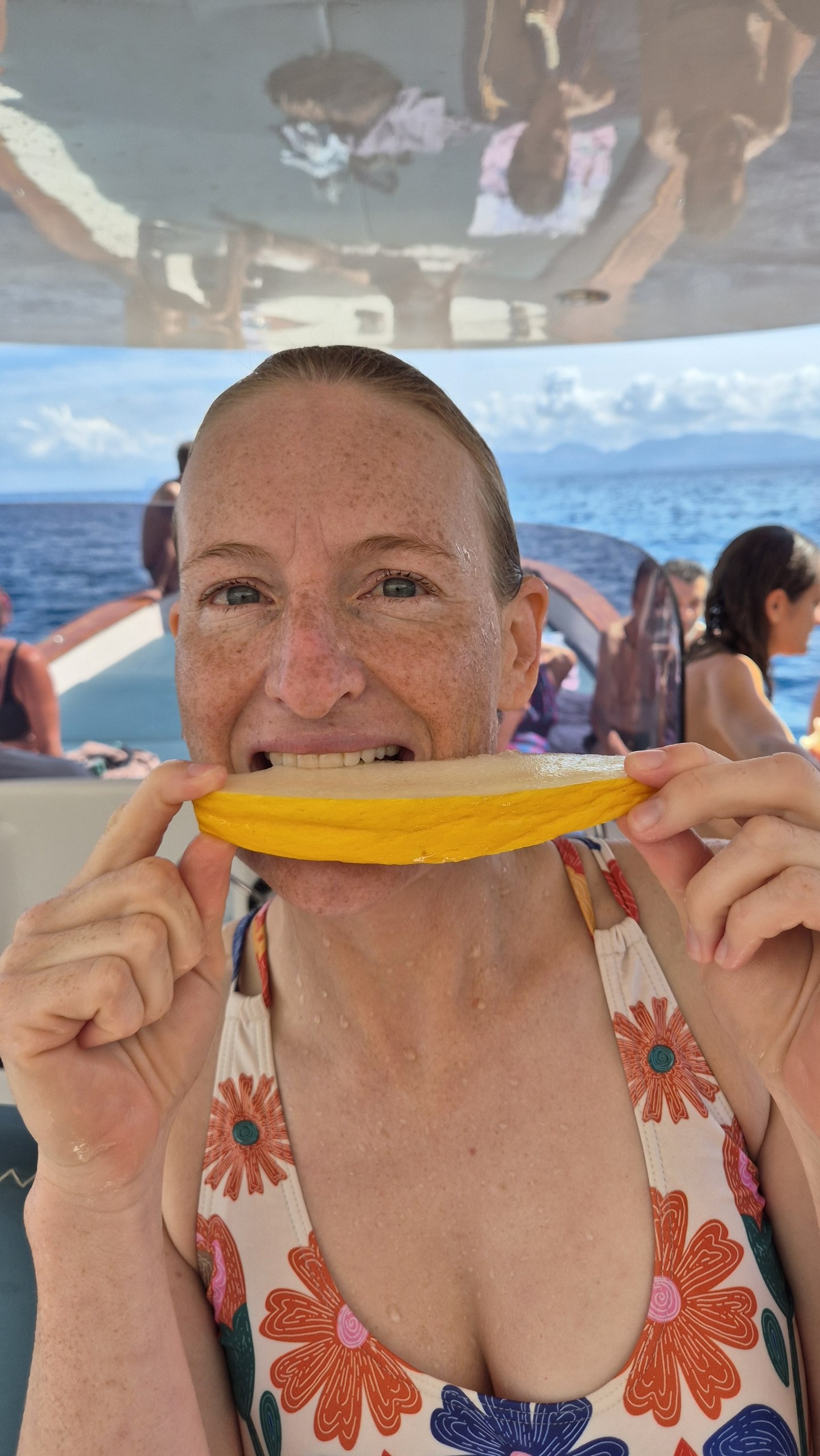 day49-caro-canary-melon Caro biting into a slice of yellow Canary melon on the boat