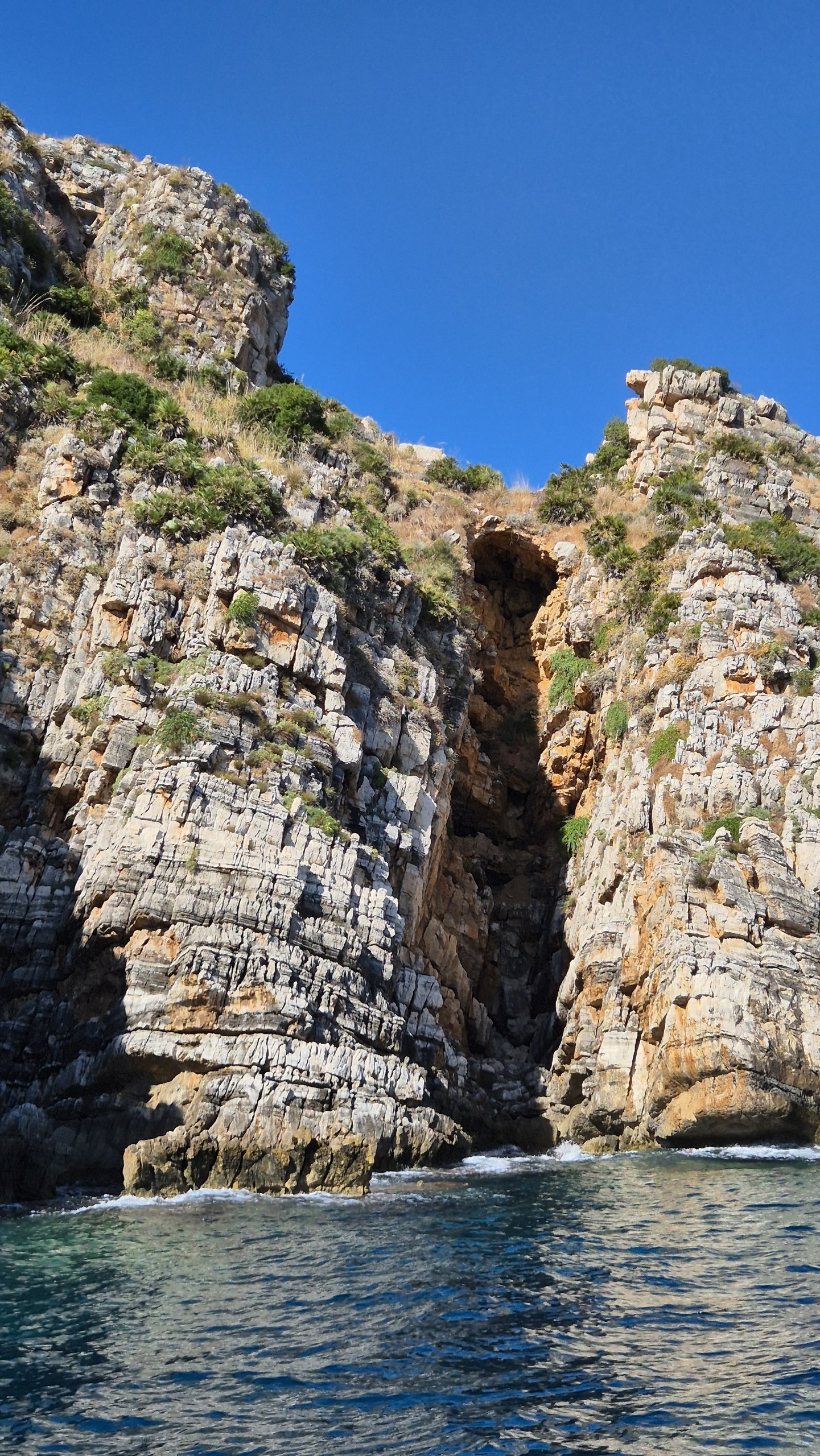 day49-cliff-cave-opening A tall cave opening in the cliffs along the coast