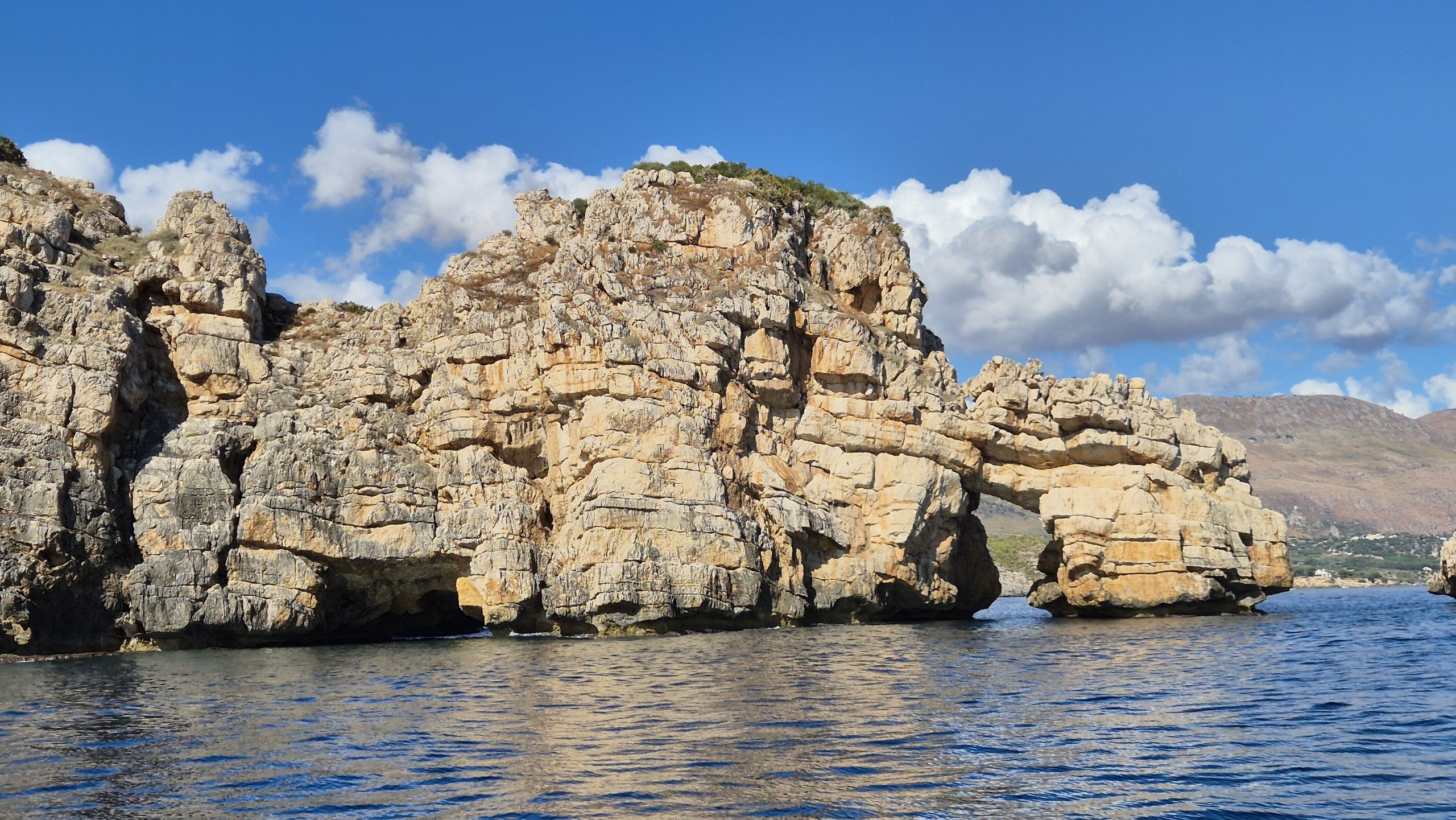 day49-limestone-headland A rugged limestone headland rising out of the water