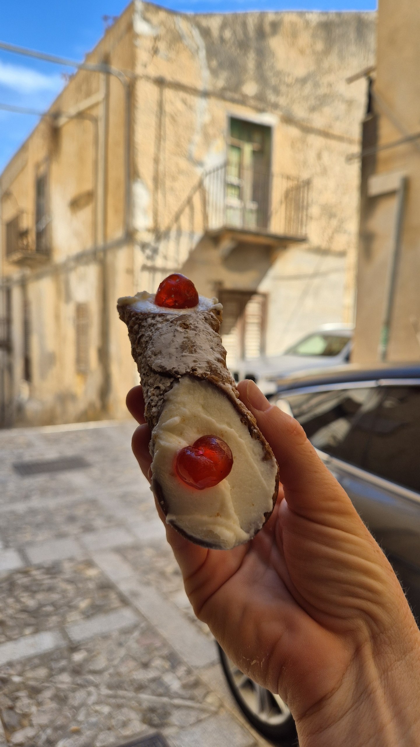 day49-ricotta-cannolo A ricotta cannolo topped with candied cherries