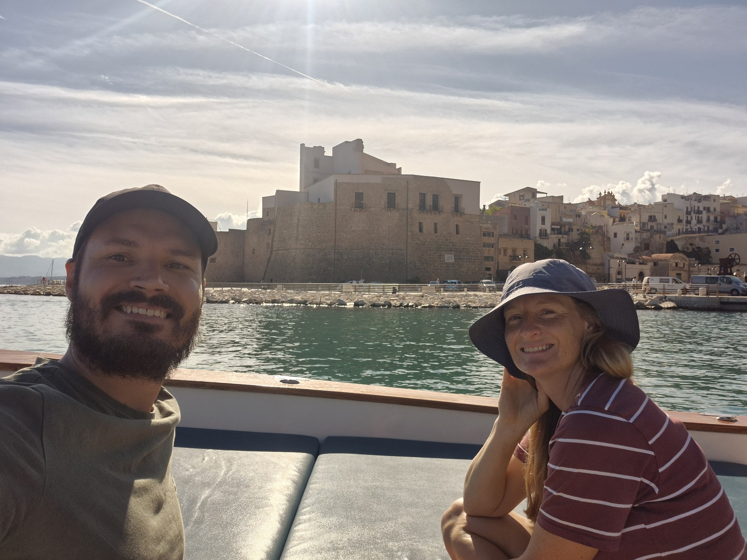 day49-selfie-leaving-castellammare Hugo and Caro aboard the boat as it leaves Castellammare del Golfo harbour