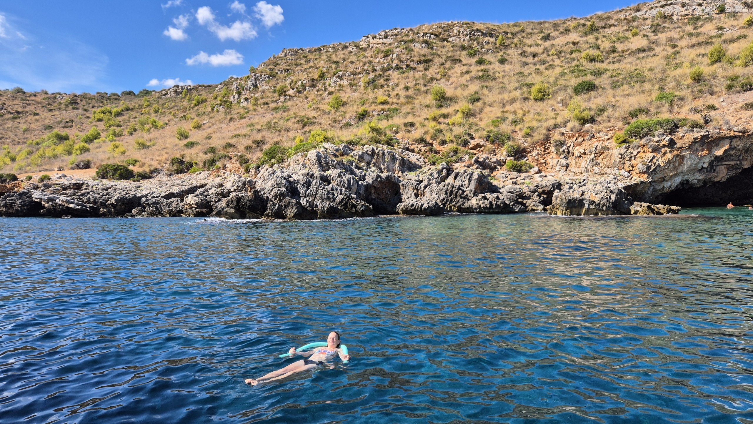 day49-swimming-below-slopes Swimming in clear blue water below the coastal slopes